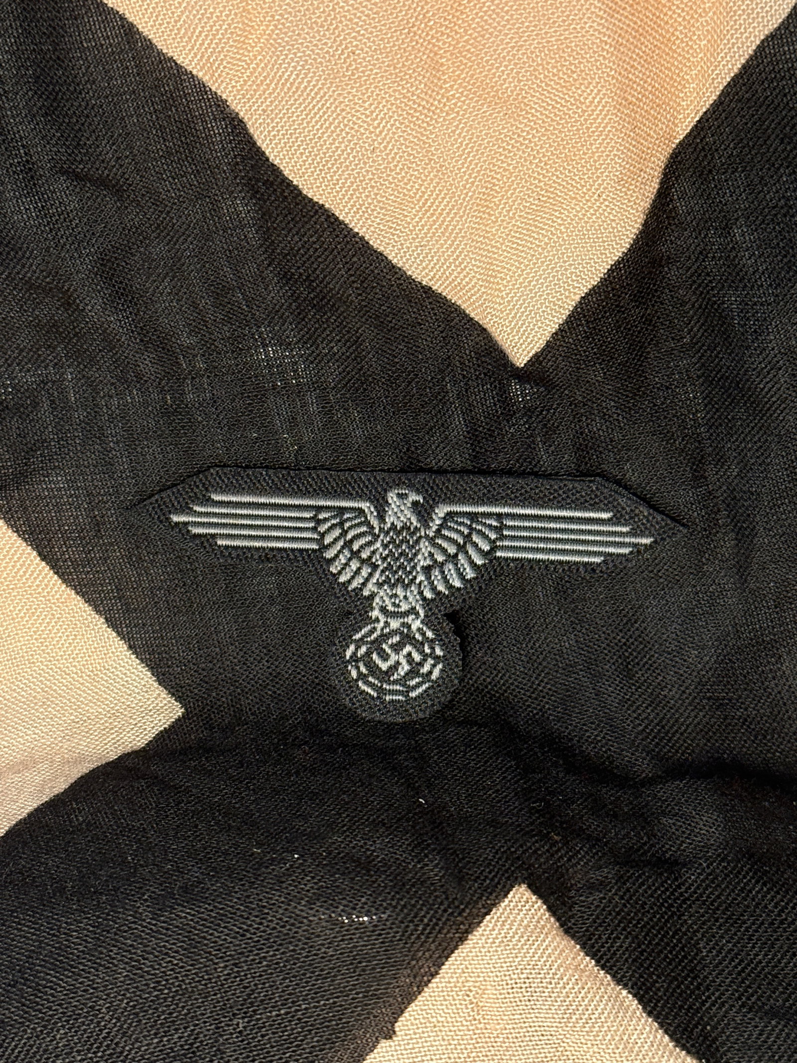 WW2 Waffen-SS BeVo Woven Sleeve Eagle Insignia, Germany, c. 1939–1945: This woven cloth insignia is a Waffen-SS sleeve eagle produced in the BeVo style, worn by members of the German Schutzstaffel (SS) during the Second World War. The insignia depicts a stylized eagle wi