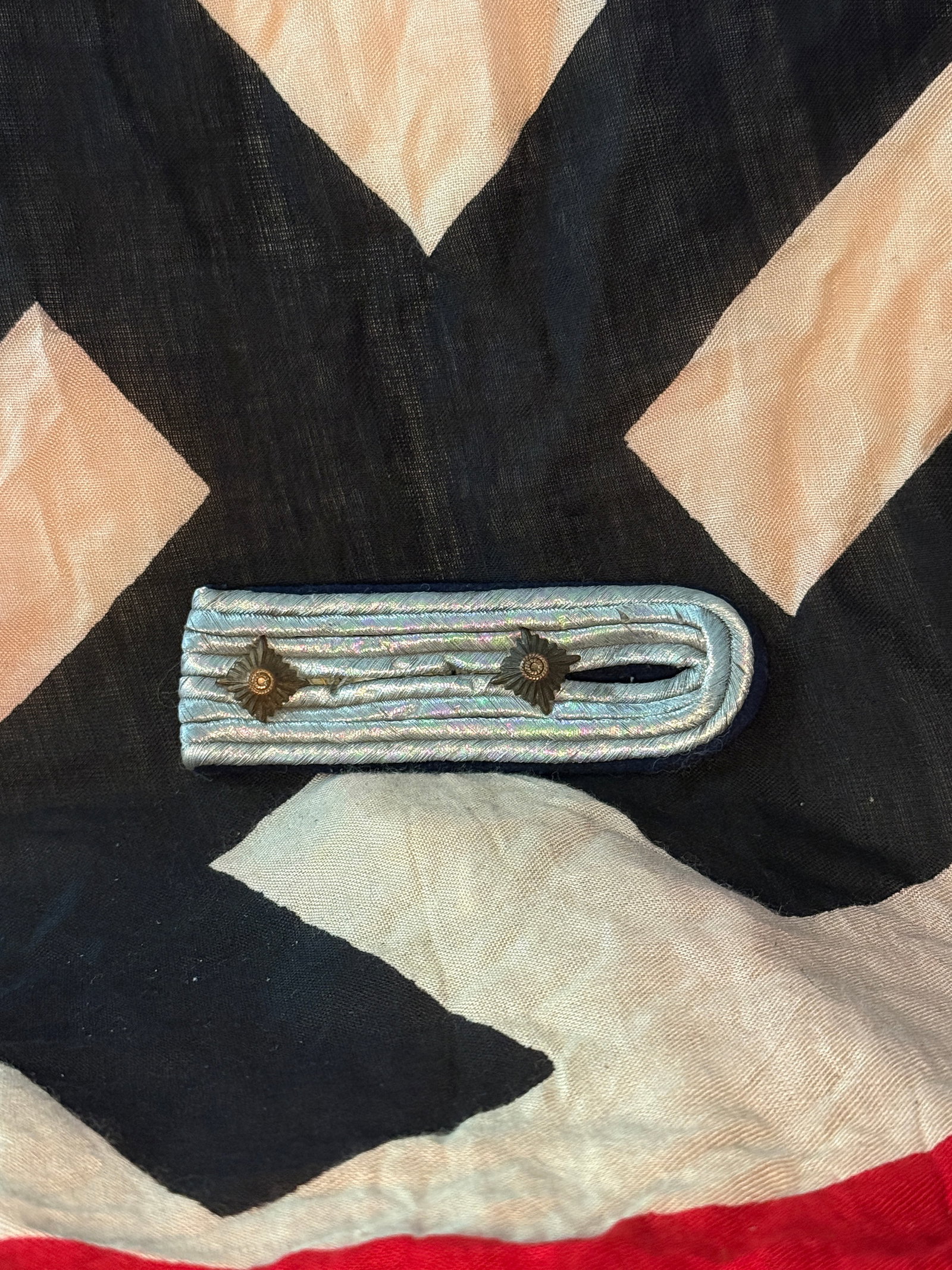 WW2 Luftwaffe Officer Shoulder Board: This braided shoulder board formed part of the uniform insignia of the Luftwaffe (German Air Force) during the Third Reich. The light-blue color associated with Luftwaffe uniforms is visible in the br