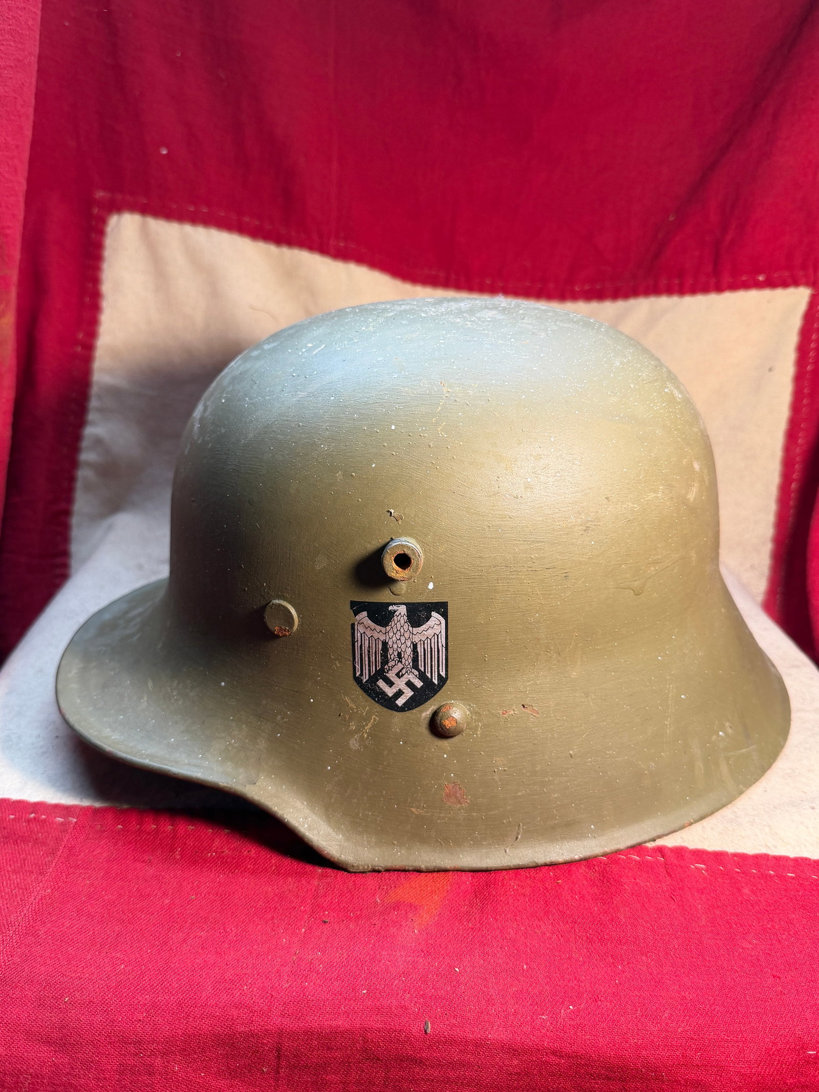 WW2 German M35 Steel Combat Helmet (Stahlhelm) with Heer Decals, c. 1935–1945: This German M35 steel helmet (Stahlhelm) was standard issue to Wehrmacht soldiers during the early and mid-years of the Second World War. Characterized by its smooth rolled edges and distinctive flare