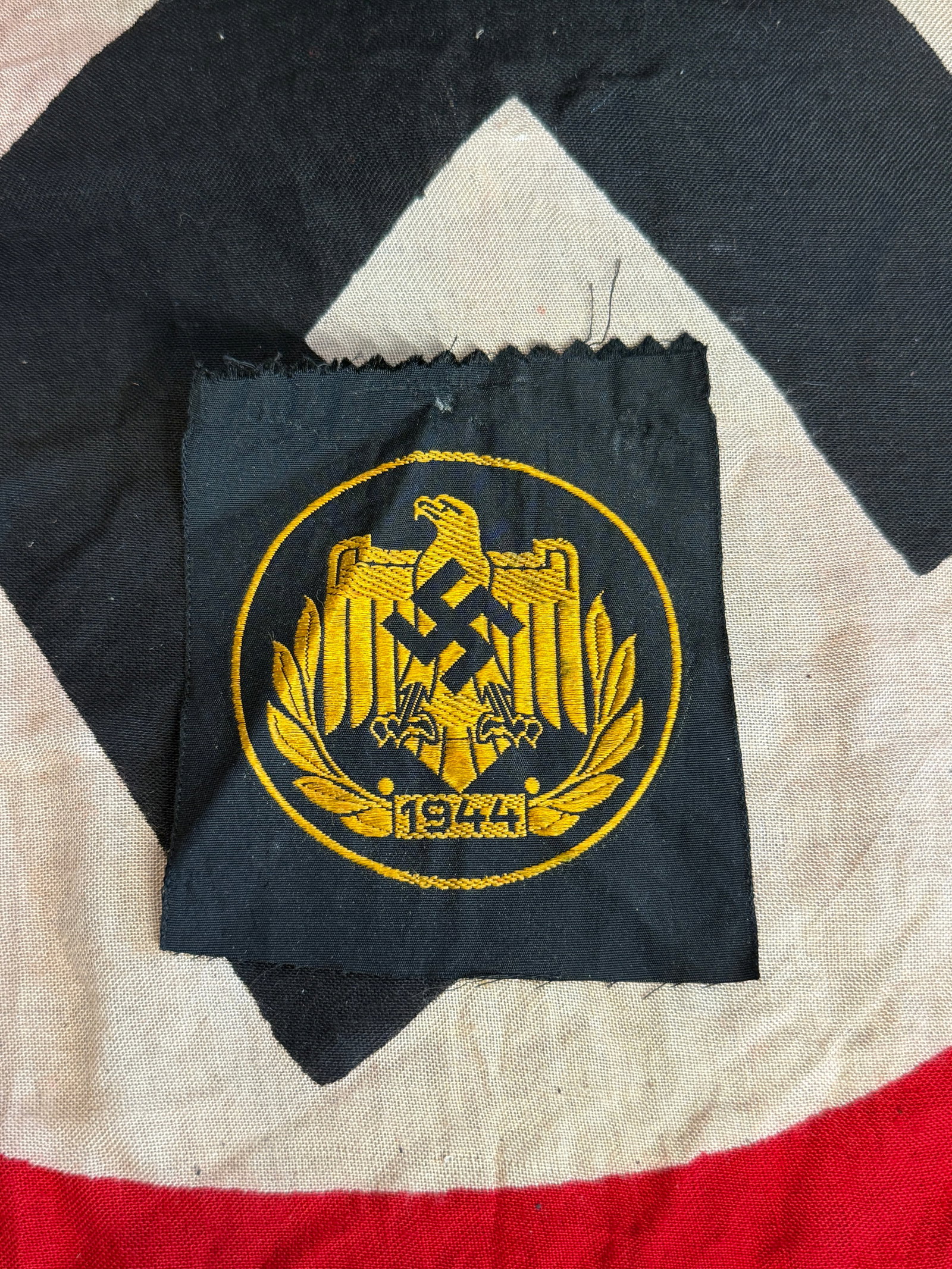 WW2 German Reichsbahn Uniform Cap Insignia: This embroidered insignia featuring a national eagle clutching a swastika within a wreath was worn on uniforms of personnel associated with the Deutsche Reichsbahn, Germany’s national railway system