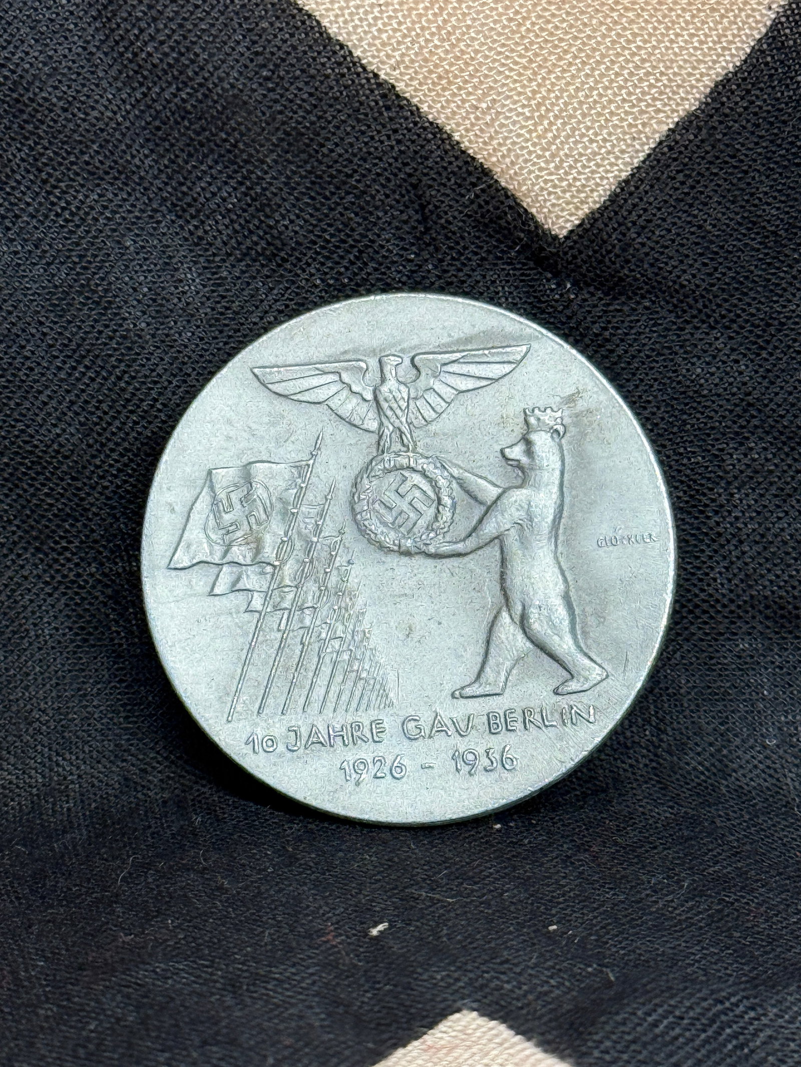 WW2 German NSDAP Gau Berlin 10-Year Anniversary Commemorative Badge (1926–1936): This commemorative badge was produced to mark the 10th anniversary of the Berlin regional district (Gau) of the National Socialist German Workers’ Party (NSDAP). The front of the badge depicts a bea