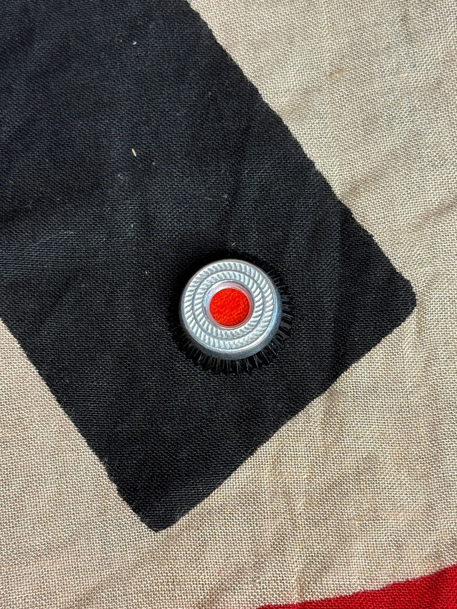 National Socialist Party Membership Lapel Badge (Parteiabzeichen): A circular enamel badge featuring a red field with a white disc and black swastika, encircled by a silver wreath. This pin was worn by members of the National Socialist German Workers’ Party (NSDAP)