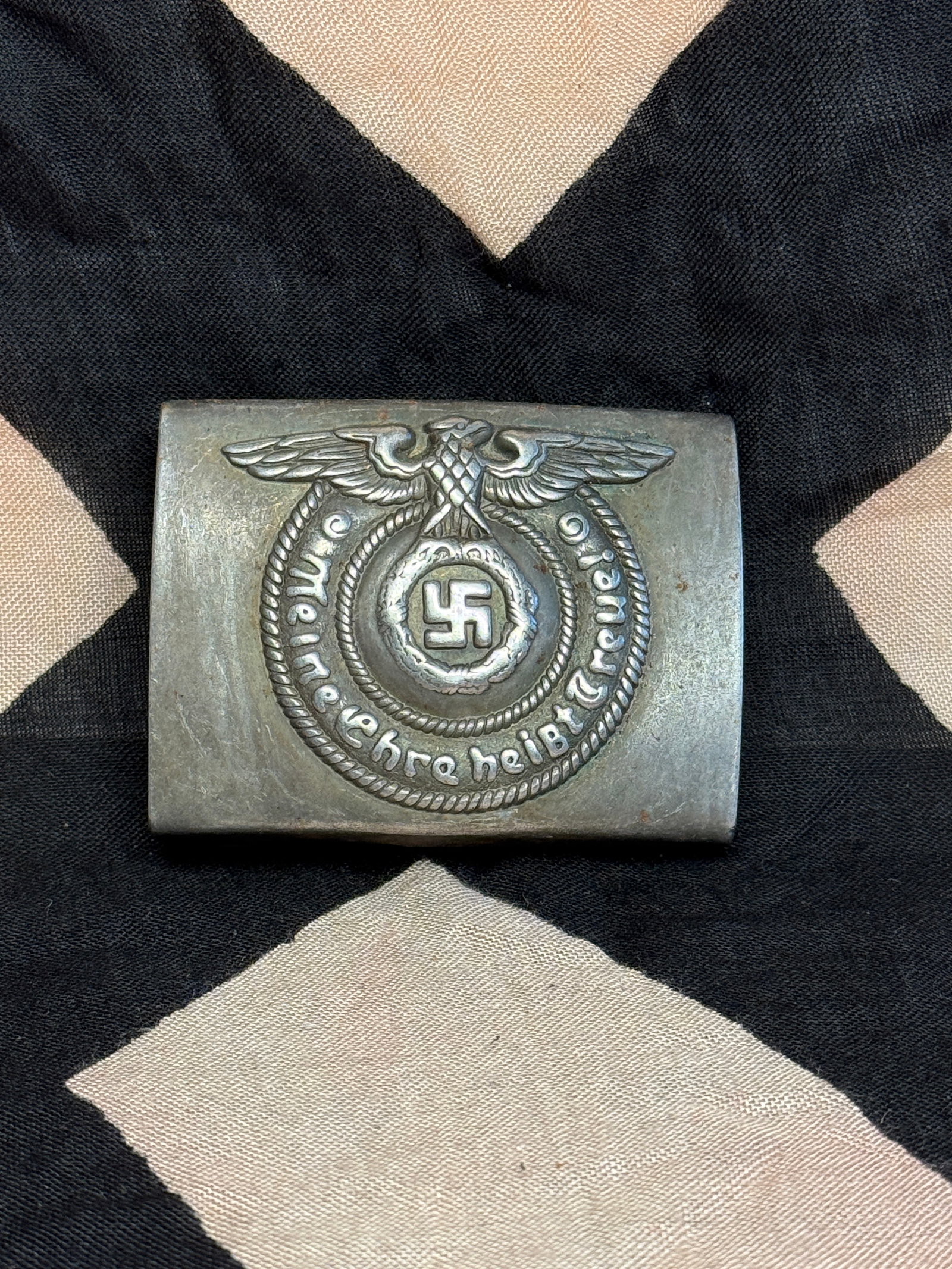 Waffen-SS Belt Buckle (“Meine Ehre heißt Treue??), WW2 Germany, c. 1936–1945: This metal belt buckle was worn by members of the Waffen-SS, the armed wing of the Schutzstaffel in Nazi Germany. The front displays an eagle with outstretched wings clutching a wreath enclosing a swa