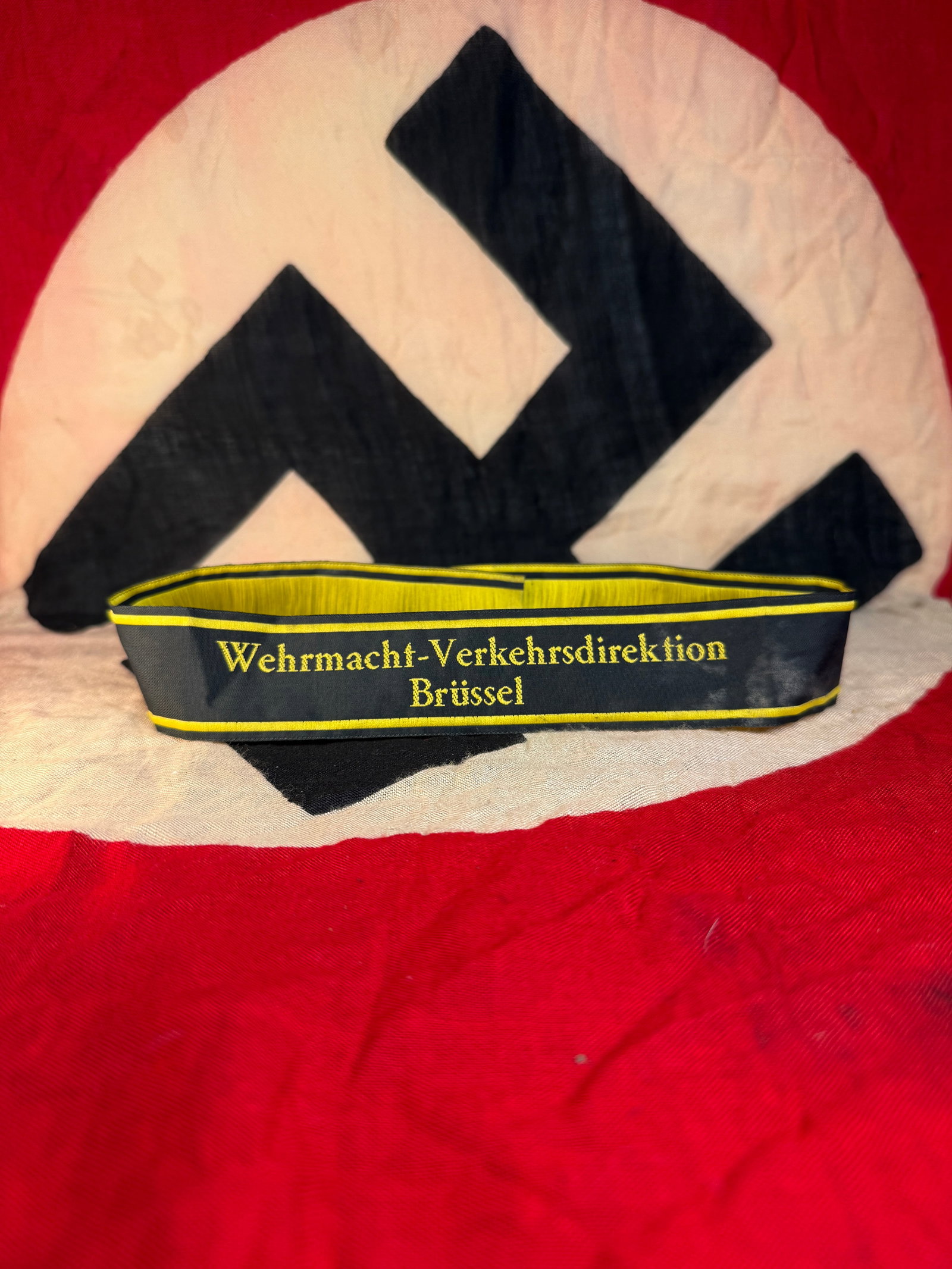 GERMAN WW2 Wehrmacht Traffic Directorate Cuff Title (Ärmelstreifen “Wehrmacht-Verkehrsdirektion: This black woven cuff title with yellow borders and lettering reads “Wehrmacht-Verkehrsdirektion Brüssel.” It was worn on the uniform sleeve by personnel assigned to military transportation a