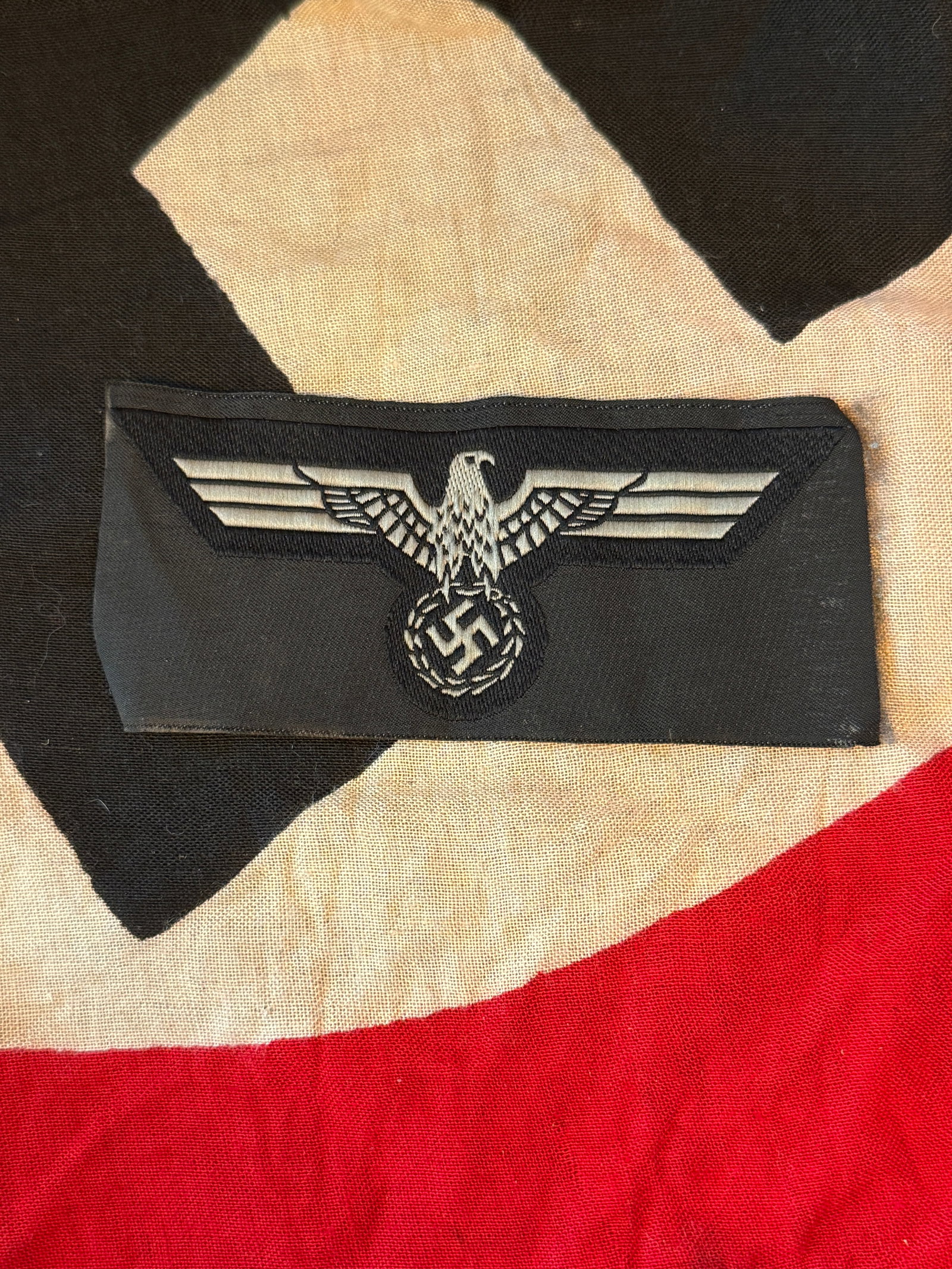 WWII UNIFORM INSIGNIA GERMAN ARMY (HEER) BREAST EAGLE: This cloth insignia is a Hoheitsabzeichen (national emblem) worn on the uniforms of the German Army (Heer) during World War II (1939–1945). The design features a stylized eagle with outstretched win