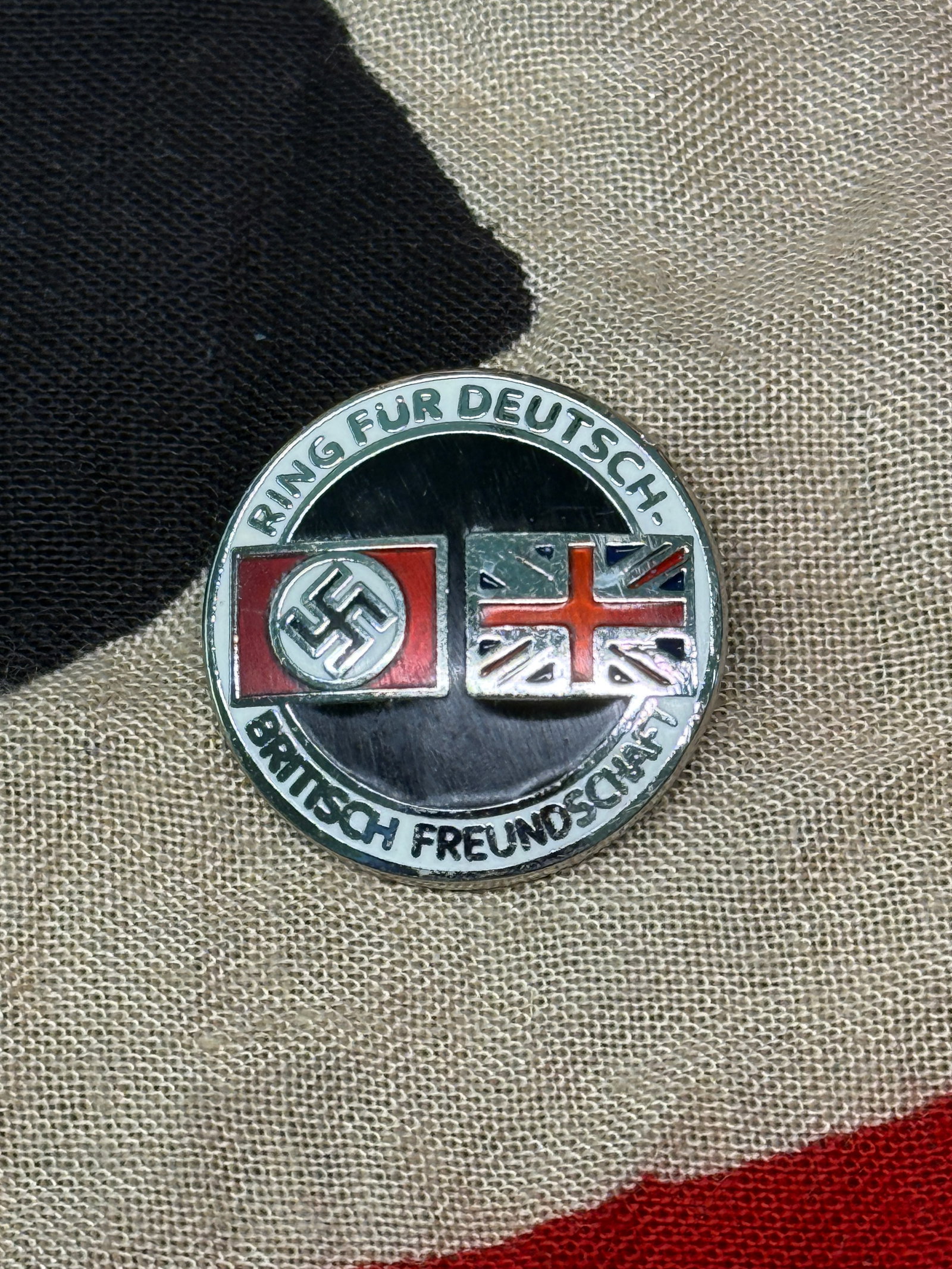 WW2 Ring für Deutsch–Britische Freundschaft Badge (German–British Friendship League), Germany,: This enamel badge bears the inscription “Ring für Deutsch–Britische Freundschaft” (“Circle for German–British Friendship”) and features both the Union Jack and the Nazi swastika f