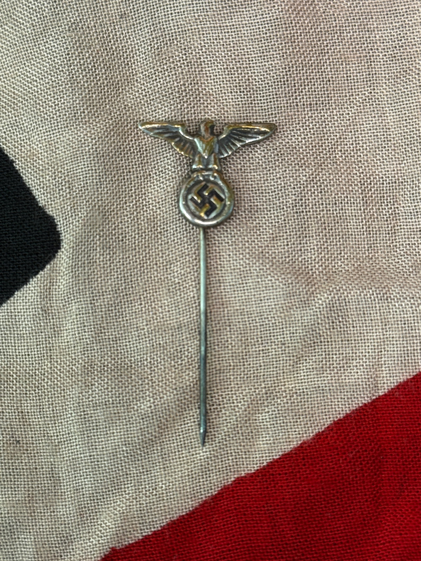WW2 German NSDAP Eagle Stick Pin, Germany, c. 1930s–1945: This stick pin depicts the eagle emblem associated with the National Socialist German Workers’ Party (NSDAP), clutching a wreath containing a swastika. Widely produced and worn by party members and
