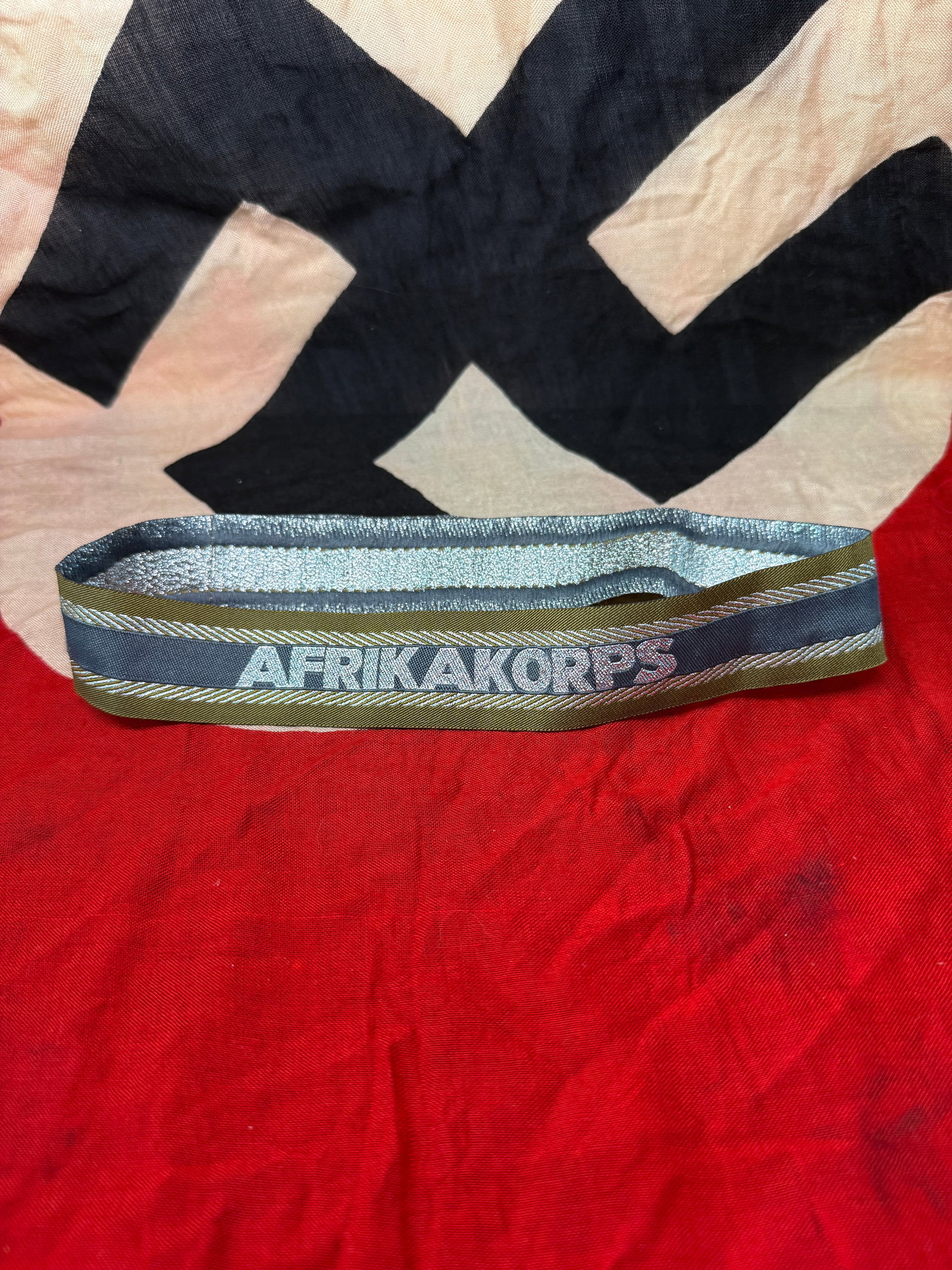 WWII German Afrika Korps Cuff Title (Ärmelstreifen), c. 1941–1943: This machine-woven cuff title, inscribed “Afrikakorps,” was worn on the lower sleeve of uniforms by personnel serving in the German Afrika Korps during the North African campaign. Introduced i