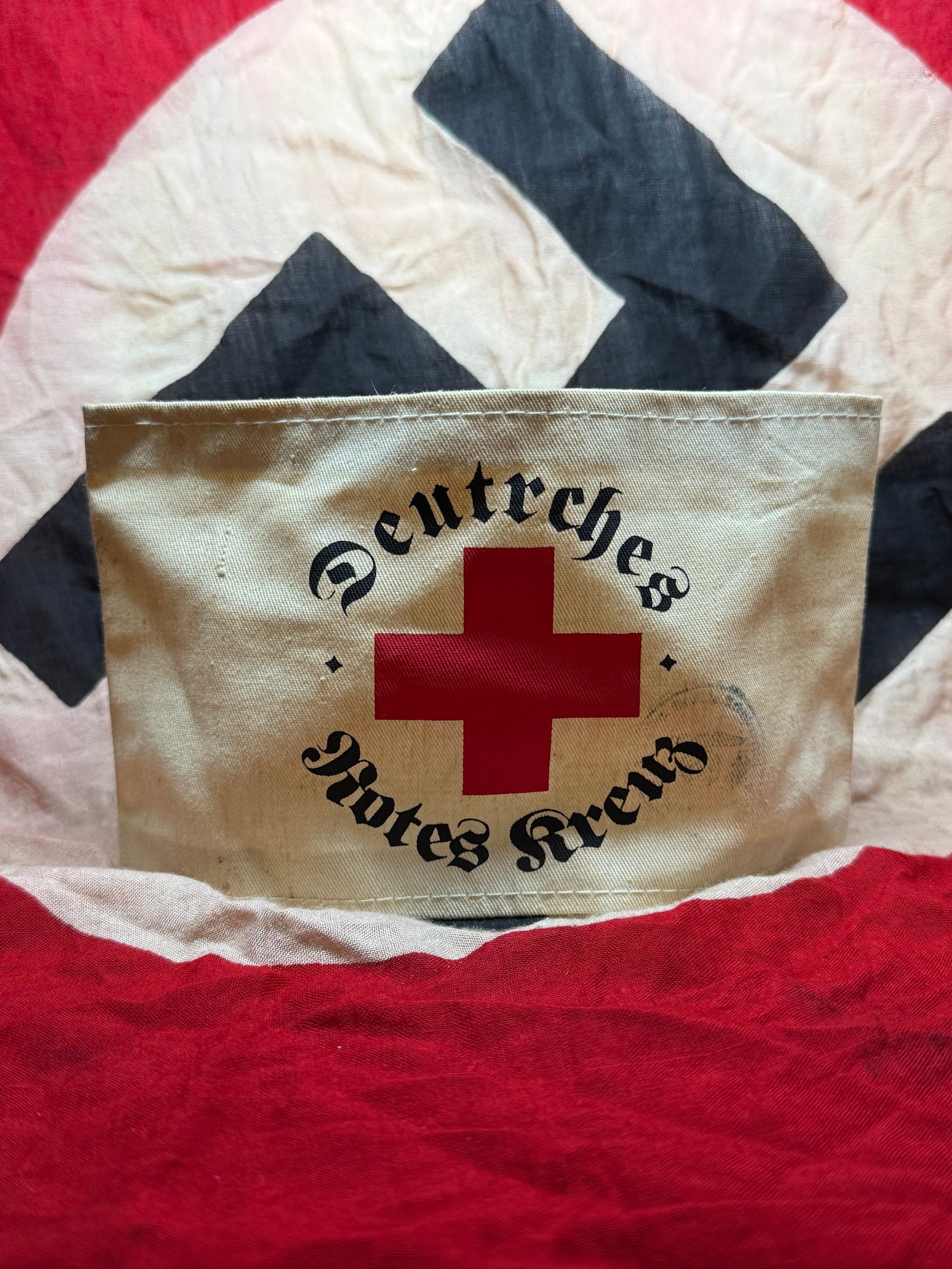 World War II German Red Cross (Deutsches Rotes Kreuz) Armband: This armband represents the German Red Cross (Deutsches Rotes Kreuz, DRK) as used during the Second World War. Constructed from white cotton fabric, it features a centrally applied red cross emblem, e