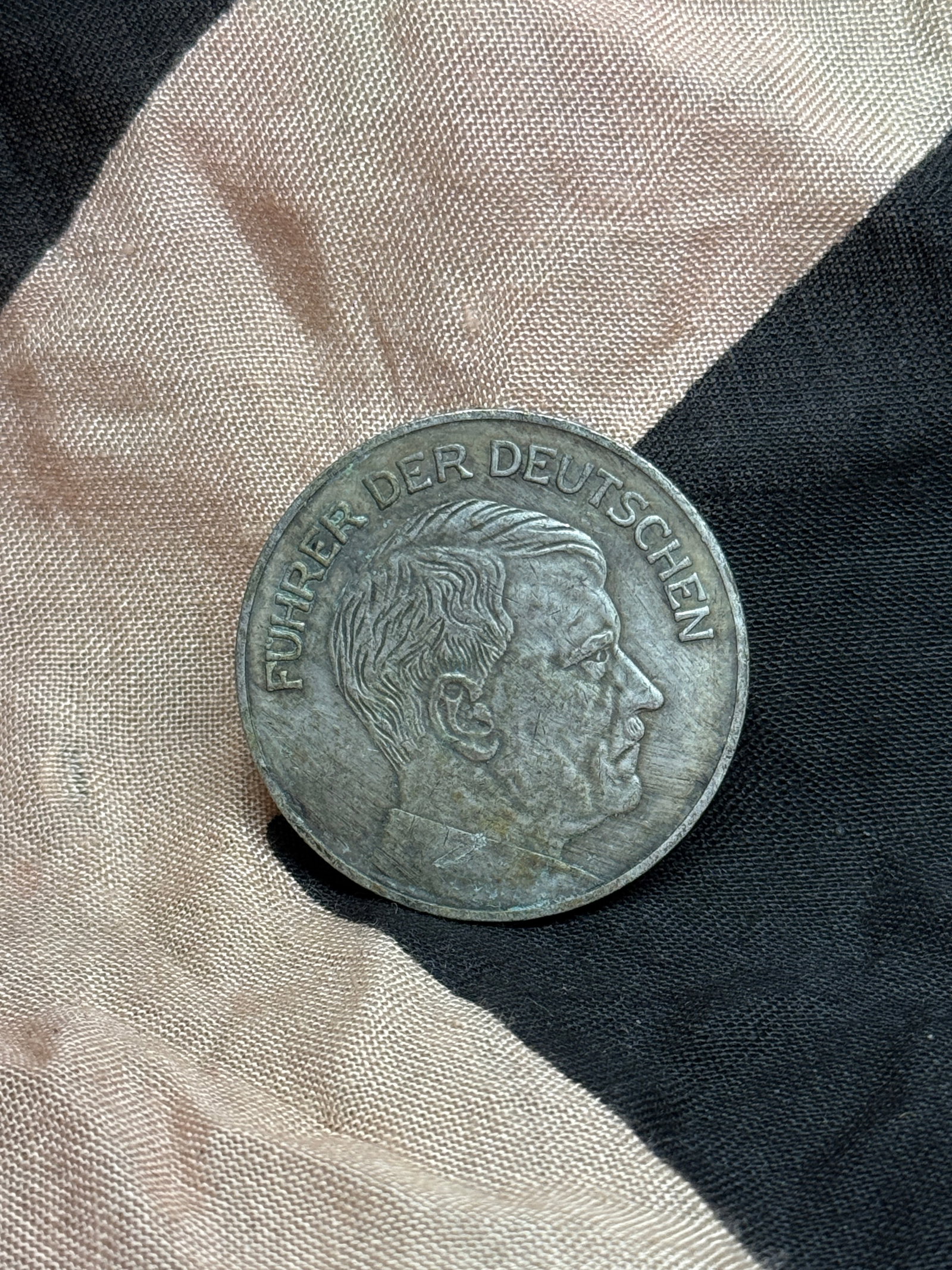 WWII German NSV Camp Achievement Medallion Featuring Adolf Hitler, Bannsee 1936: This circular German medallion features a right-facing portrait of Adolf Hitler with the inscription “Führer der Deutschen” (“Leader of the Germans”) on the obverse. The reverse reads