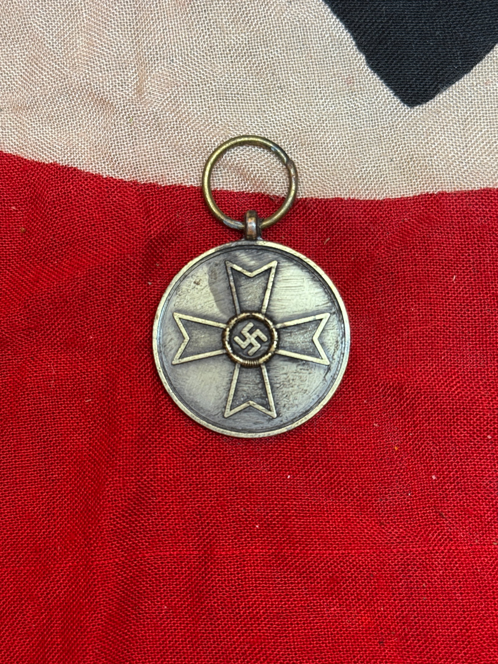 World War II German War Merit Medal (Kriegsverdienstmedaille), 1939: The War Merit Medal (Kriegsverdienstmedaille) was instituted in 1939 to recognize civilians and military personnel for contributions to the war effort not involving direct combat. The obverse features