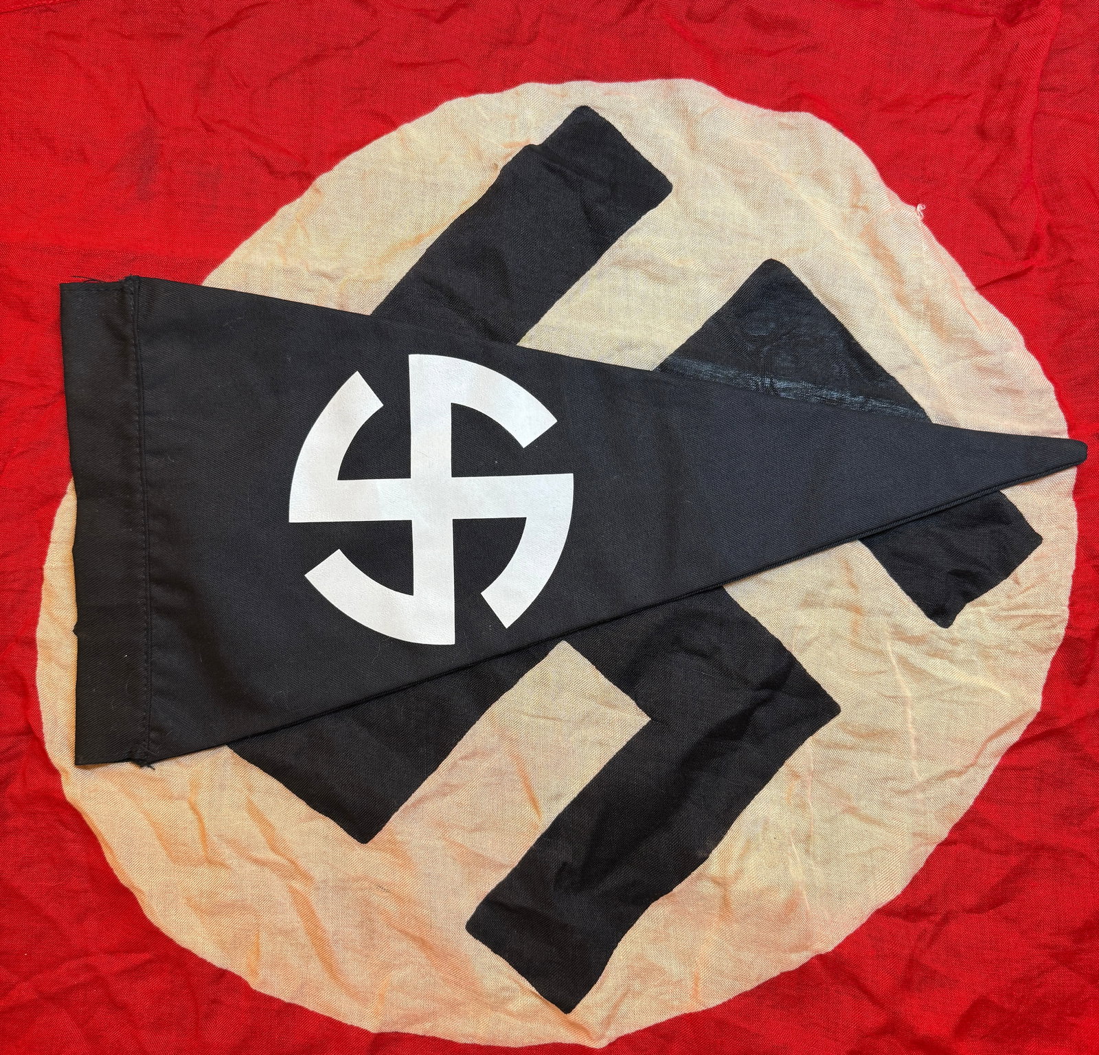 WWII German NSDAP Banner Pennant (Swallowtail Form), c. 1933–1945: This black swallowtail-style pennant is an example of political and organizational insignia used in Nazi Germany during the Third Reich. Constructed from black cloth, the banner features a white circu
