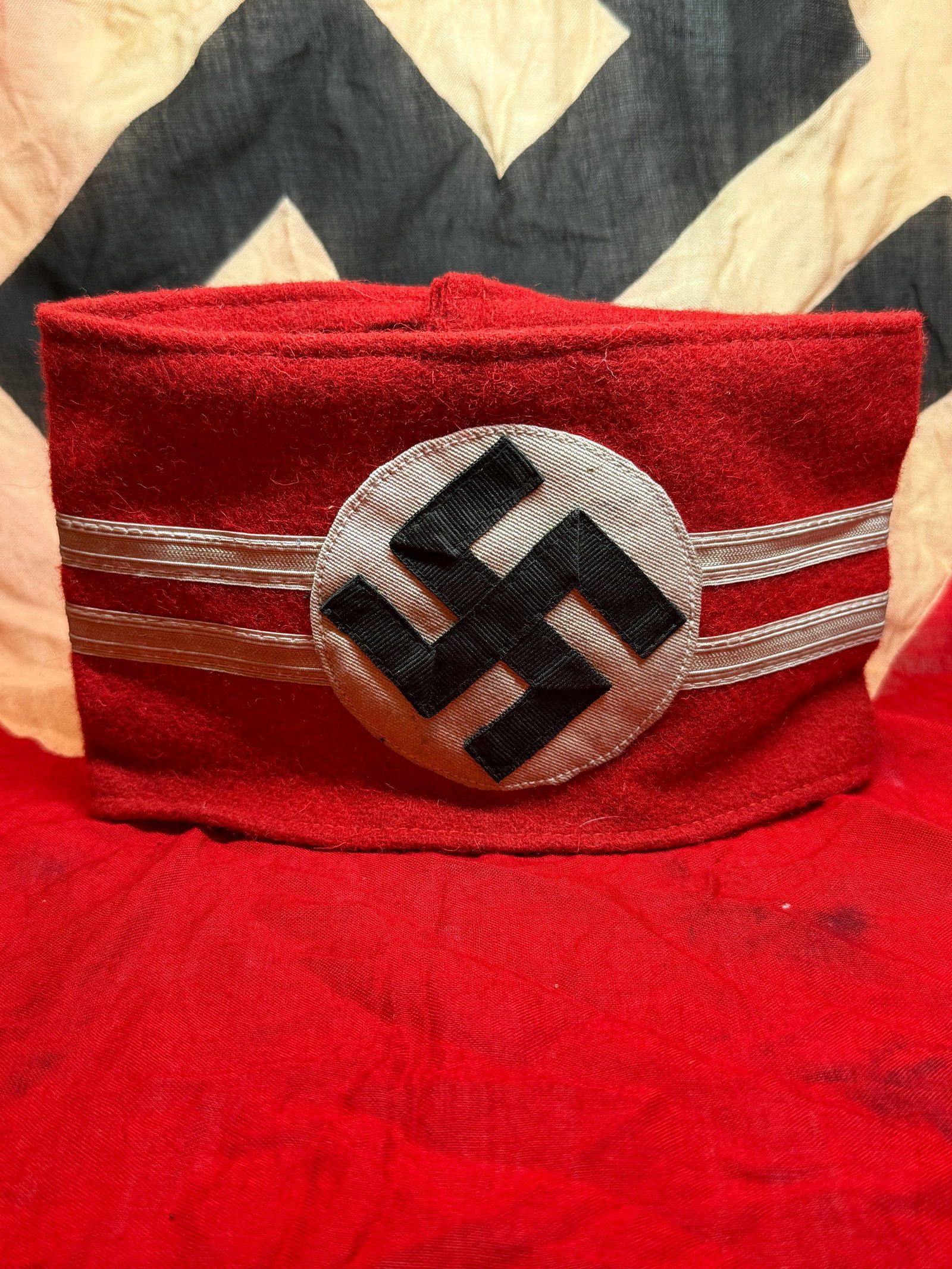 WWII German Political Organization Armband (NSDAP Style) With RZM Paper Tag: This red cloth armband with a central white roundel and black swastika is emblematic of political and paramilitary organizations in Nazi Germany, most notably the National Socialist German Workers’