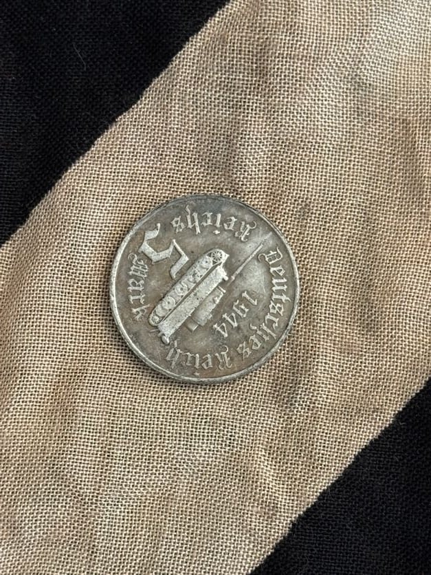 WWII German Third Reich Reichspfennig Coin (Circulation Currency): This small-denomination coin represents everyday currency used in Germany during the Third Reich. Reichspfennig coins were minted in various denominations and materials, typically zinc or copper alloy