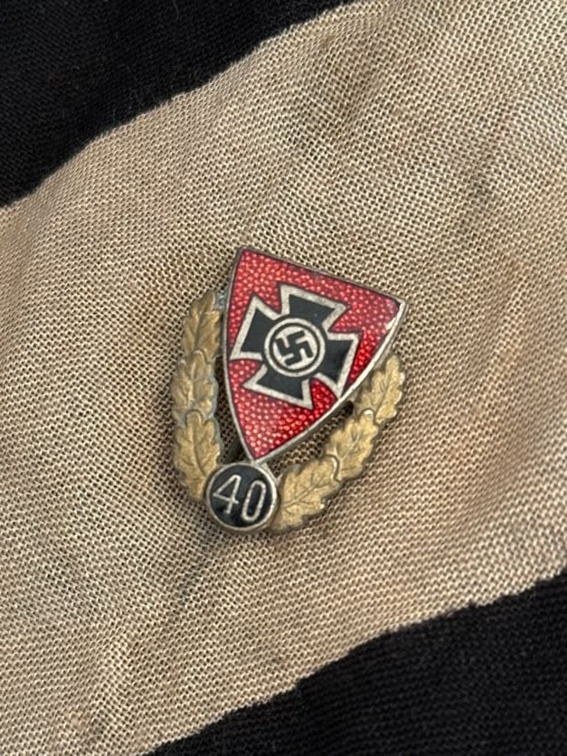 WWII German Veteran or Service Commemorative Badge with Iron Cross Motif (“40?? Device): This enamel badge features an Iron Cross design set against a red field, framed by a wreath and topped with the number “40.” Such badges are typically associated with commemorative or veteran-