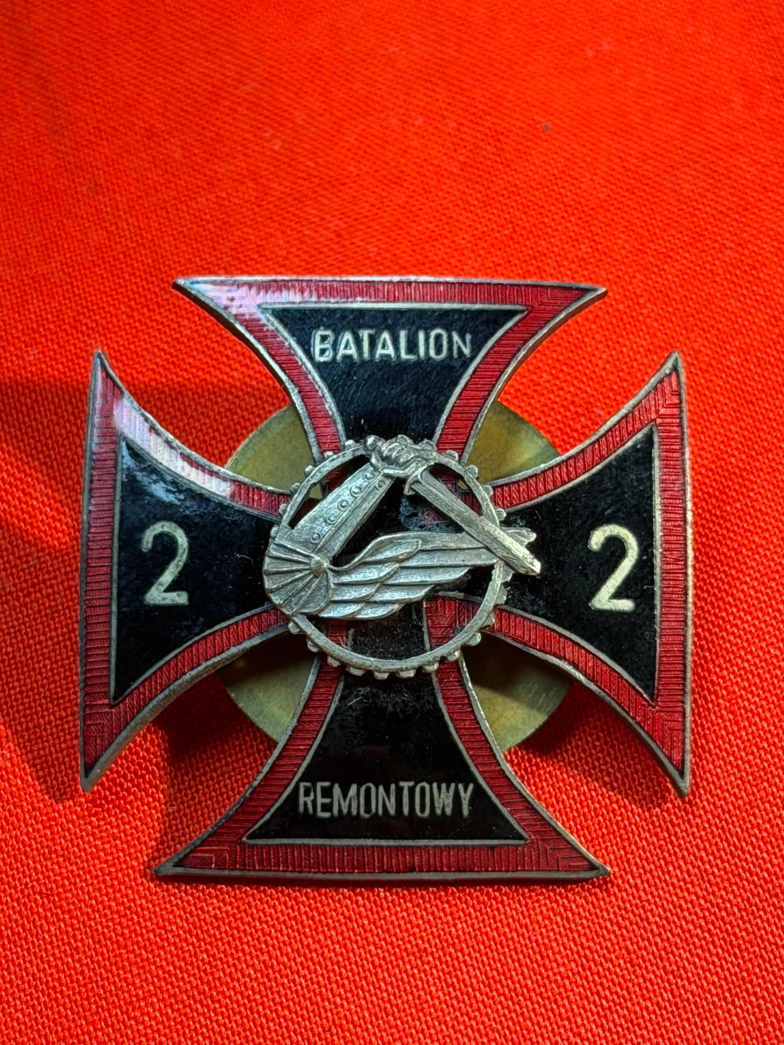WW2 Badge of the 2nd Repair Battalion ("2 Batalion Remontowy"), Poland: This enameled metal badge represents the 2nd Repair Battalion (Polish: 2 Batalion Remontowy), a unit associated with technical and maintenance support within the Polish armed forces. The cross-shaped
