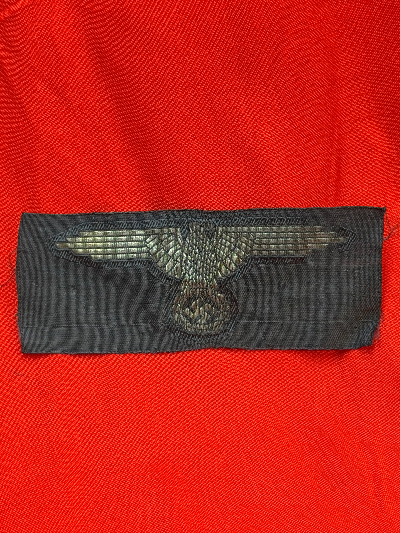WW2 Waffen-SS Sleeve Eagle Insignia (BeVo Woven), Nazi Germany, c. 1930s–1940s: This woven cloth insignia depicts the stylized eagle clutching a wreath enclosing a swastika, a prominent emblem used by the Waffen-SS during the Second World War. Manufactured in the BeVo weaving sty