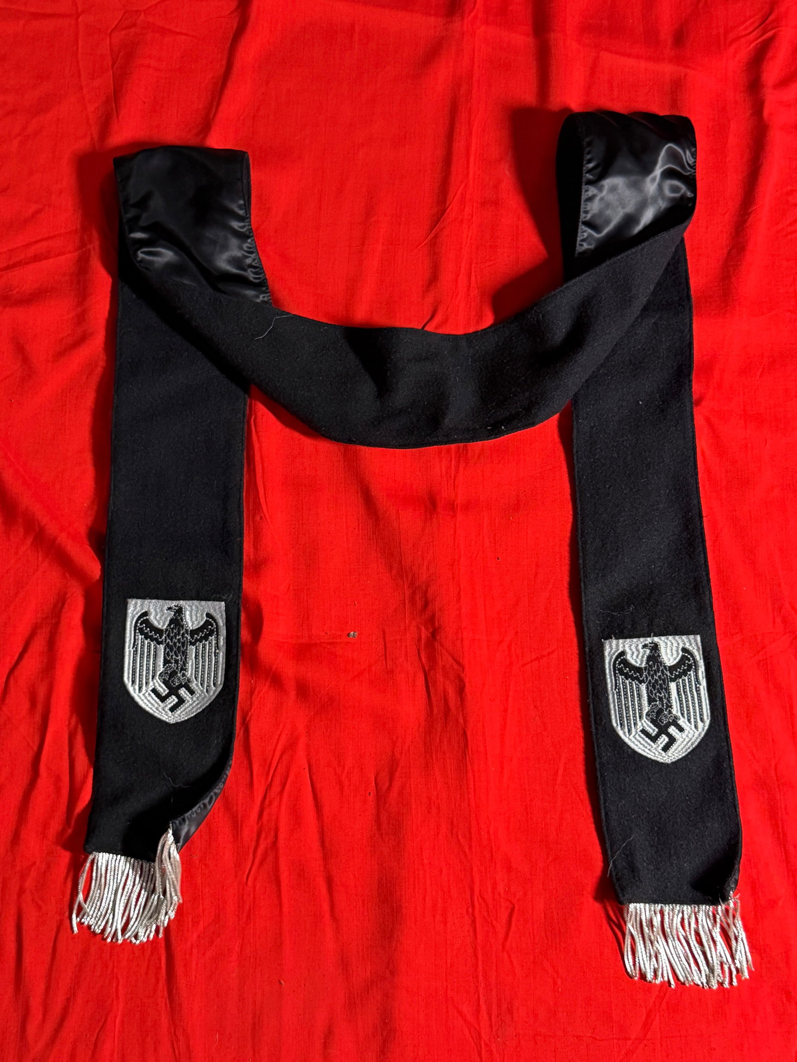 WW2 German Wehrmacht Funeral Sash with Embroidered Eagle Insignia: This black funeral sash features a long, draped wool construction with a smooth satin-style lining at each end, designed for formal wear during memorial or ceremonial occasions. Both hanging panels di