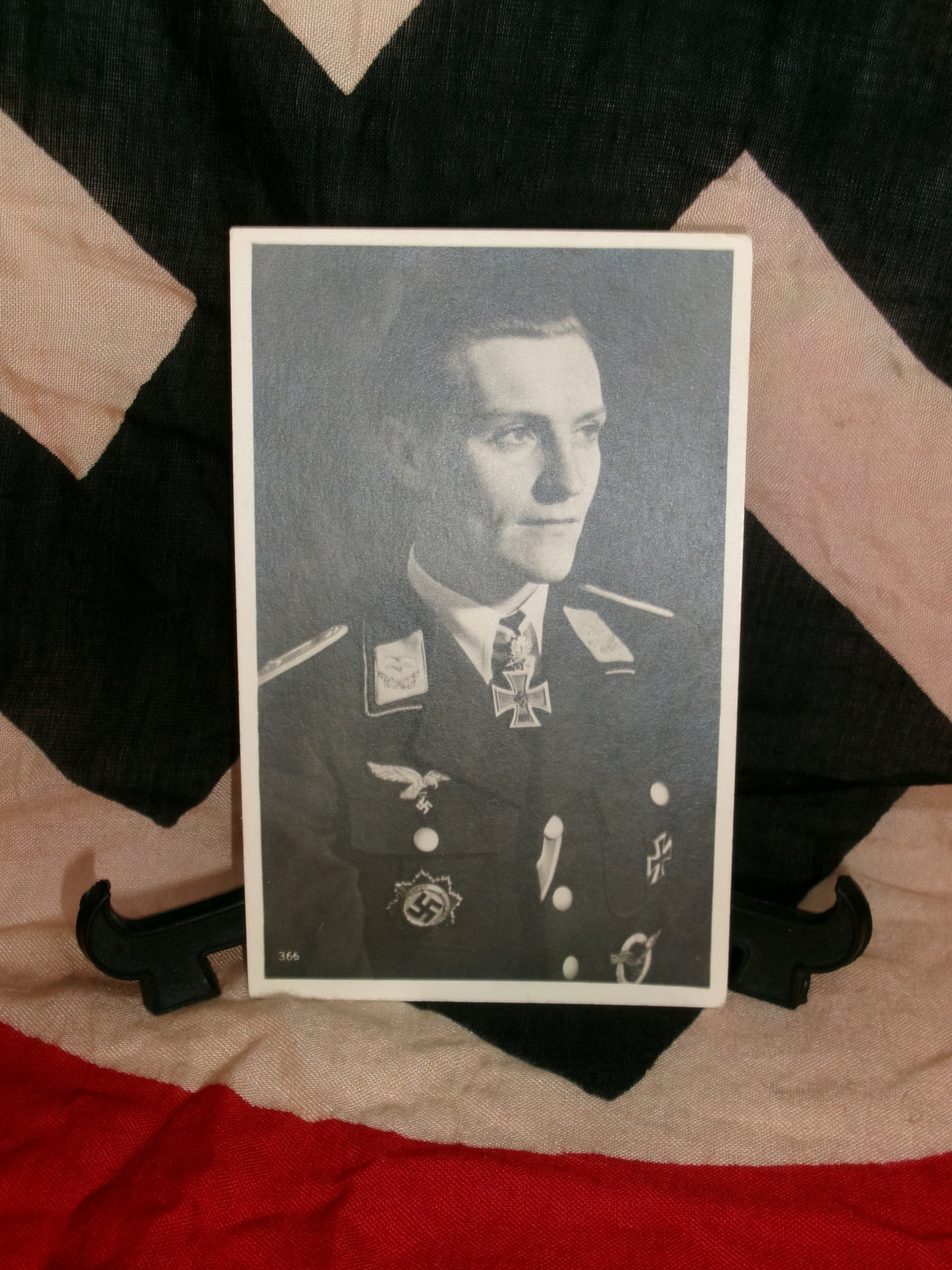 WWII German Luftwaffe Officer Portrait Photograph: A formal studio portrait of a German Luftwaffe officer wearing a decorated uniform, including a Knight’s Cross at the neck and other insignia. While the identity of the individual is not confirmed, 