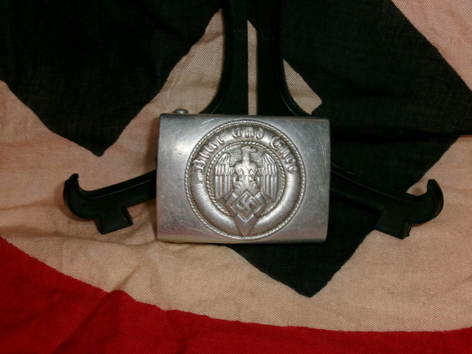 WWII German Belt Buckle (Wehrmacht “Gott mit uns??): A metal German military belt buckle bearing the national eagle and the inscription “Gott mit uns” (“God with us”). Issued to Wehrmacht personnel, these buckles were part of standard fi