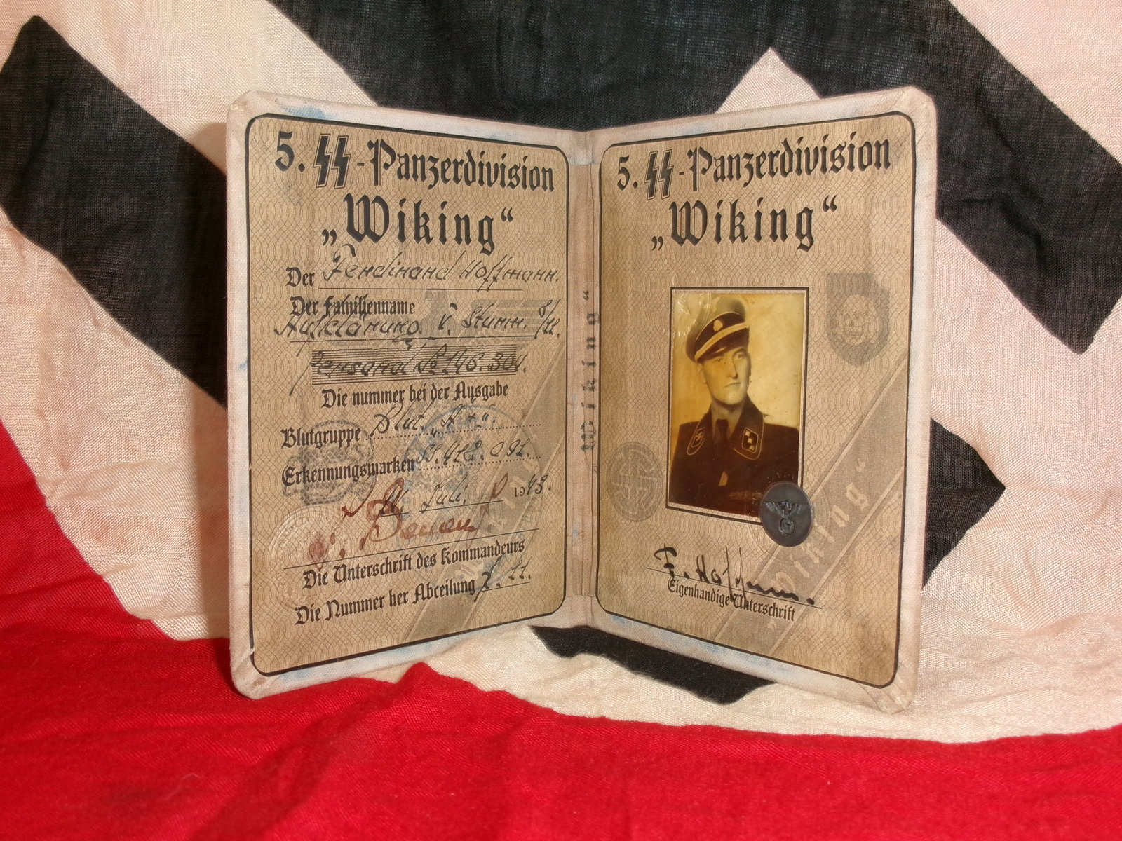WWII Waffen-SS Identification Document – 5th SS Panzer Division “Wiking: An identification booklet issued to a member of the 5th SS Panzer Division “Wiking,” a Waffen-SS armored unit composed of German and foreign volunteers. The document includes a photograph, per