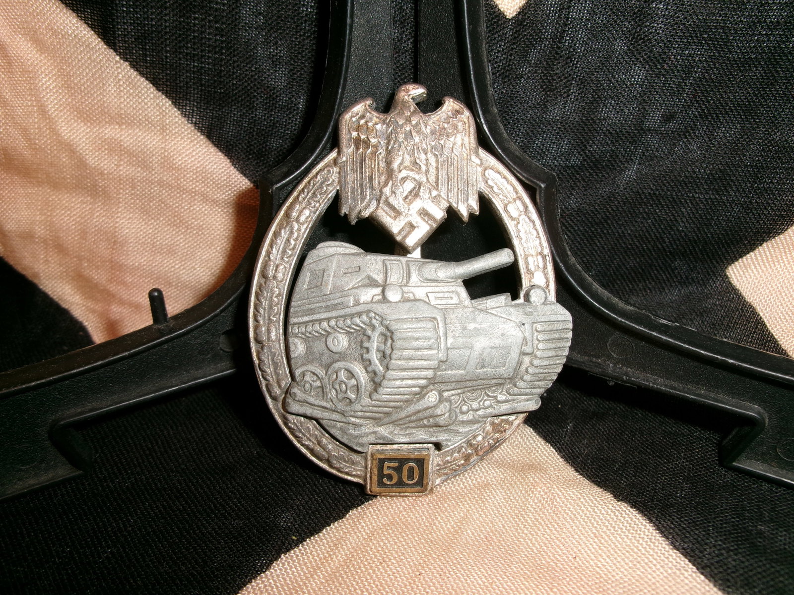 WWII German Panzer Assault Badge with “50?? Engagement Clasp (Panzerkampfabzeichen By JFS: This German Panzer Assault Badge (Panzerkampfabzeichen) represents one of the most recognized armored warfare decorations of the Second World War. Maker marked JFS on the reverse. The oval oakleaf wre