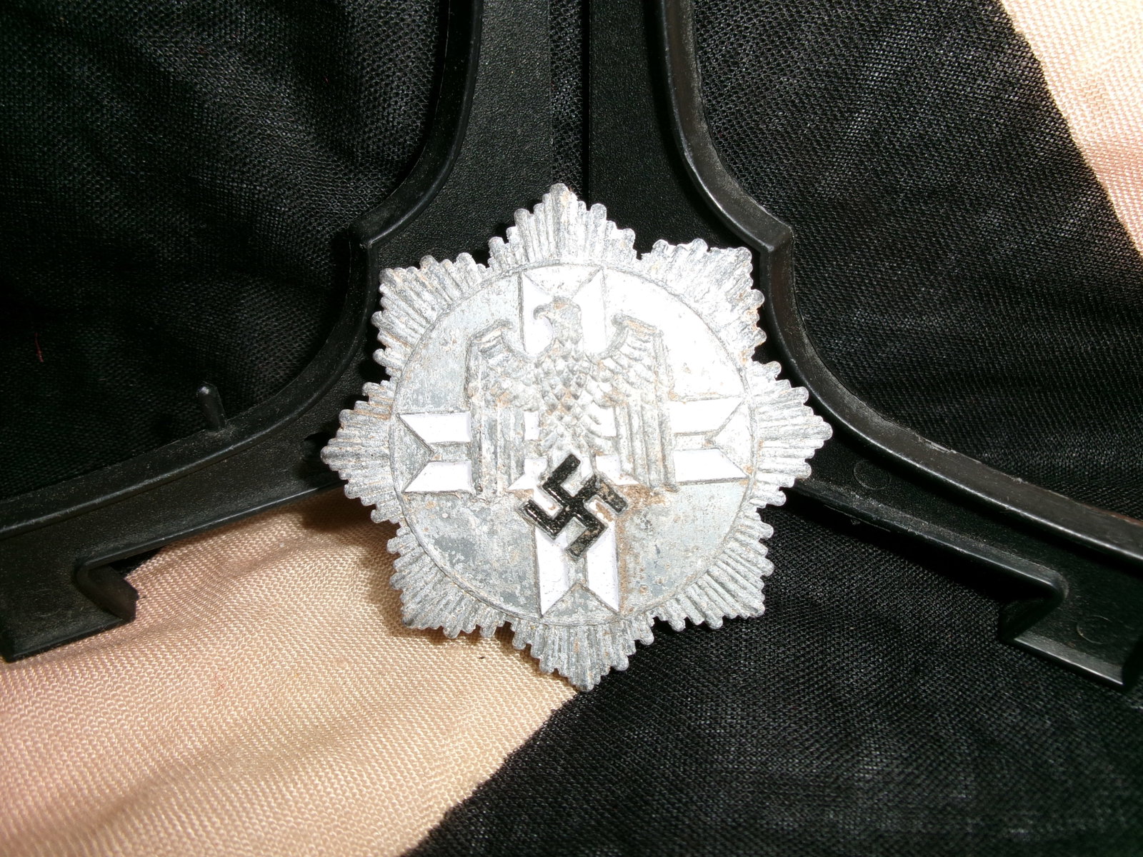 WWII German Ordnungspolizei Officer Breast Star Badge: A German Ordnungspolizei (Order Police) officer’s breast star, constructed in a multi-rayed design with a central circular medallion featuring the national eagle above a wreath enclosing a swastika.