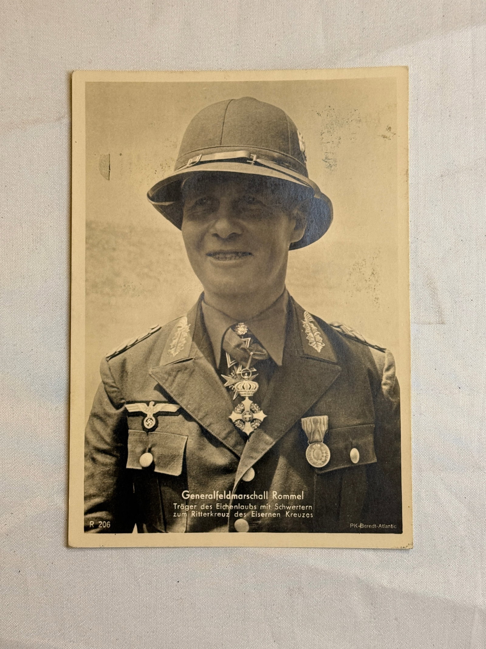 WWII German Soldier Portrait Photograph with Awards: A black-and-white studio portrait photograph depicting a German soldier wearing a steel helmet and decorated uniform. Visible awards include a medal bar and breast decorations, indicating recognized s