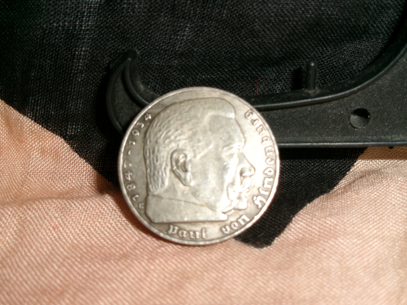 WWII German 5 Reichsmark Silver Coin, Paul von Hindenburg Commemorative (1936): A silver 5 Reichsmark coin featuring the profile of President Paul von Hindenburg on the obverse, inscribed with his name and life dates. The reverse displays the national eagle above a swastika, alon