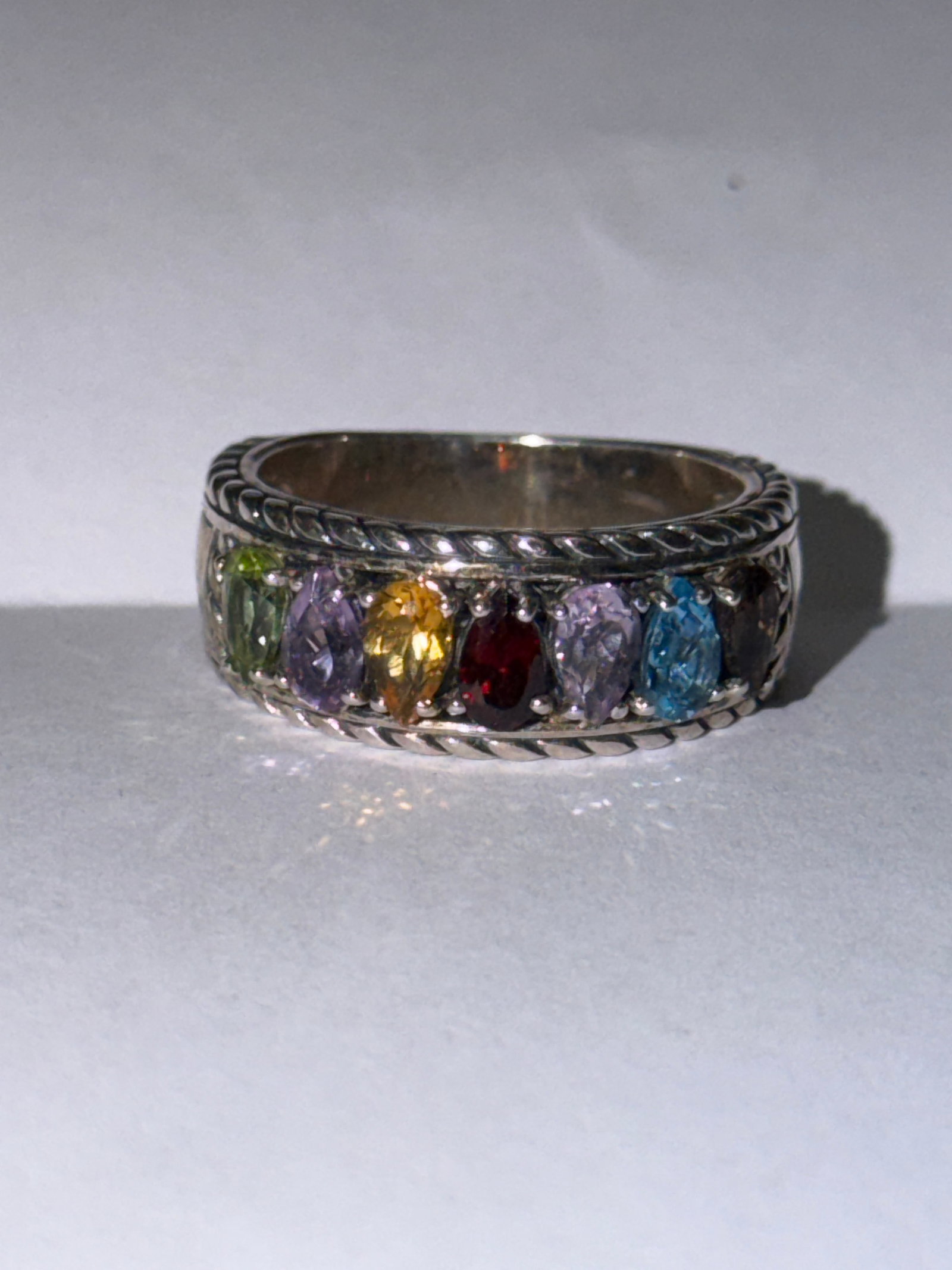 Effy Multi Stone Sterling Silver Band Ring Sz 6: Striking Effy band ring crafted in sterling silver, featuring a vibrant array of multi-colored stones set across the front. The design showcases a mix of hues including green, purple, yellow, red, and