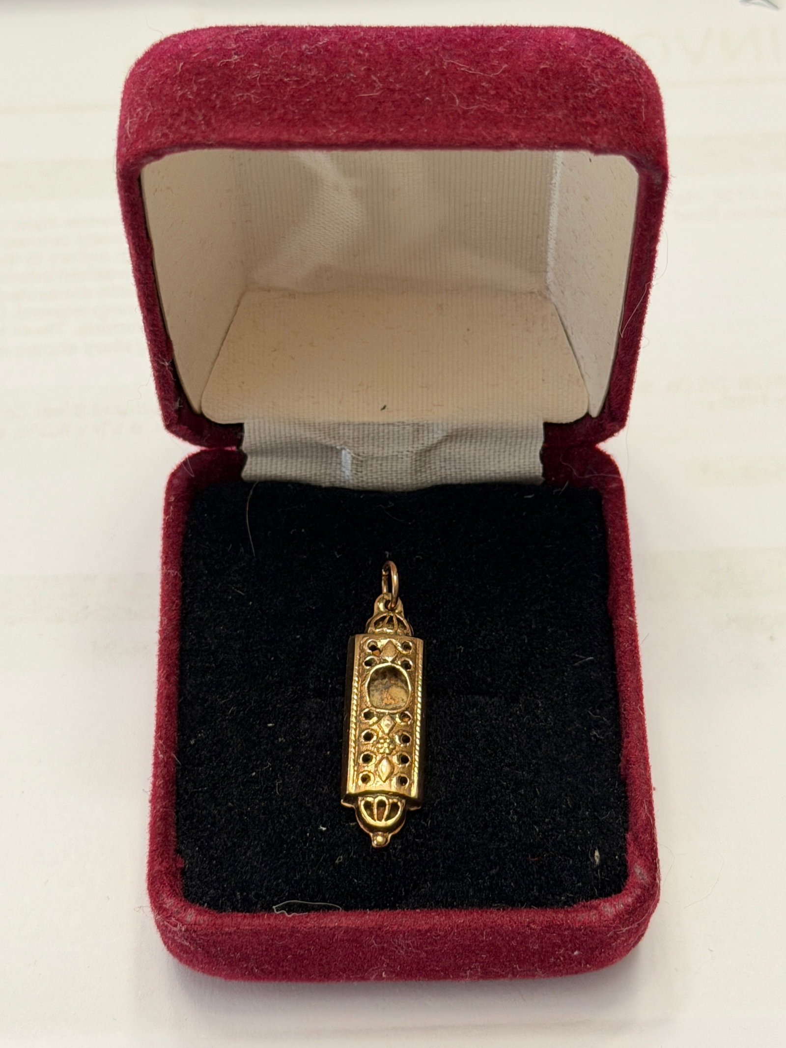 Israel 14K Gold El Shaddai Pendant Depicting A Mezuzah: A beautifully crafted vintage pendant in solid 14K gold, designed in the form of a traditional mezuzah case. The front features intricate decorative detailing with an openwork design and a central rec