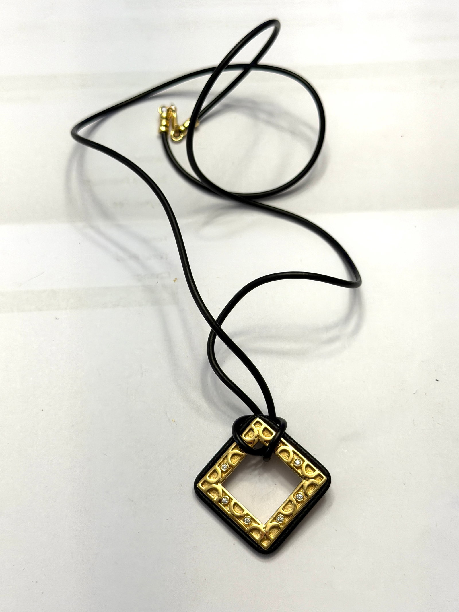 Designer 18K Gold With Diamonds Cocktail Necklace: Stylish designer necklace featuring a bold geometric pendant crafted in rich 18K yellow gold, accented with sparkling diamonds. The open square (diamond-shaped) pendant showcases a modern yet timeless