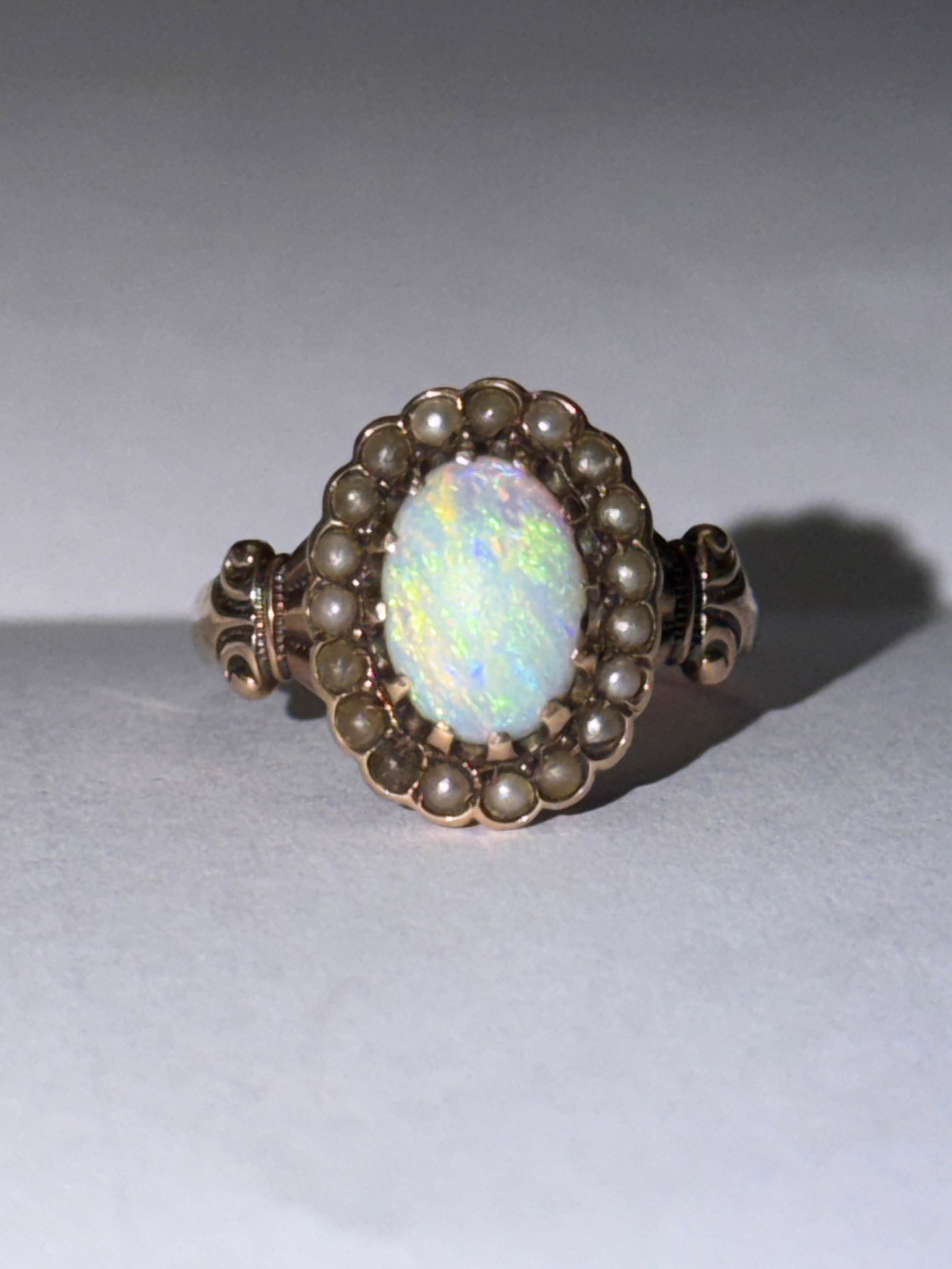 Victorian 14K Gold Black Pearls & Fire Opal Ladies Ring Sz 5.5: Elegant antique Victorian-era ring crafted in solid 14K gold, featuring a mesmerizing oval fire opal centerpiece with vibrant flashes of green, blue, and warm undertones. The opal is beautifully frame