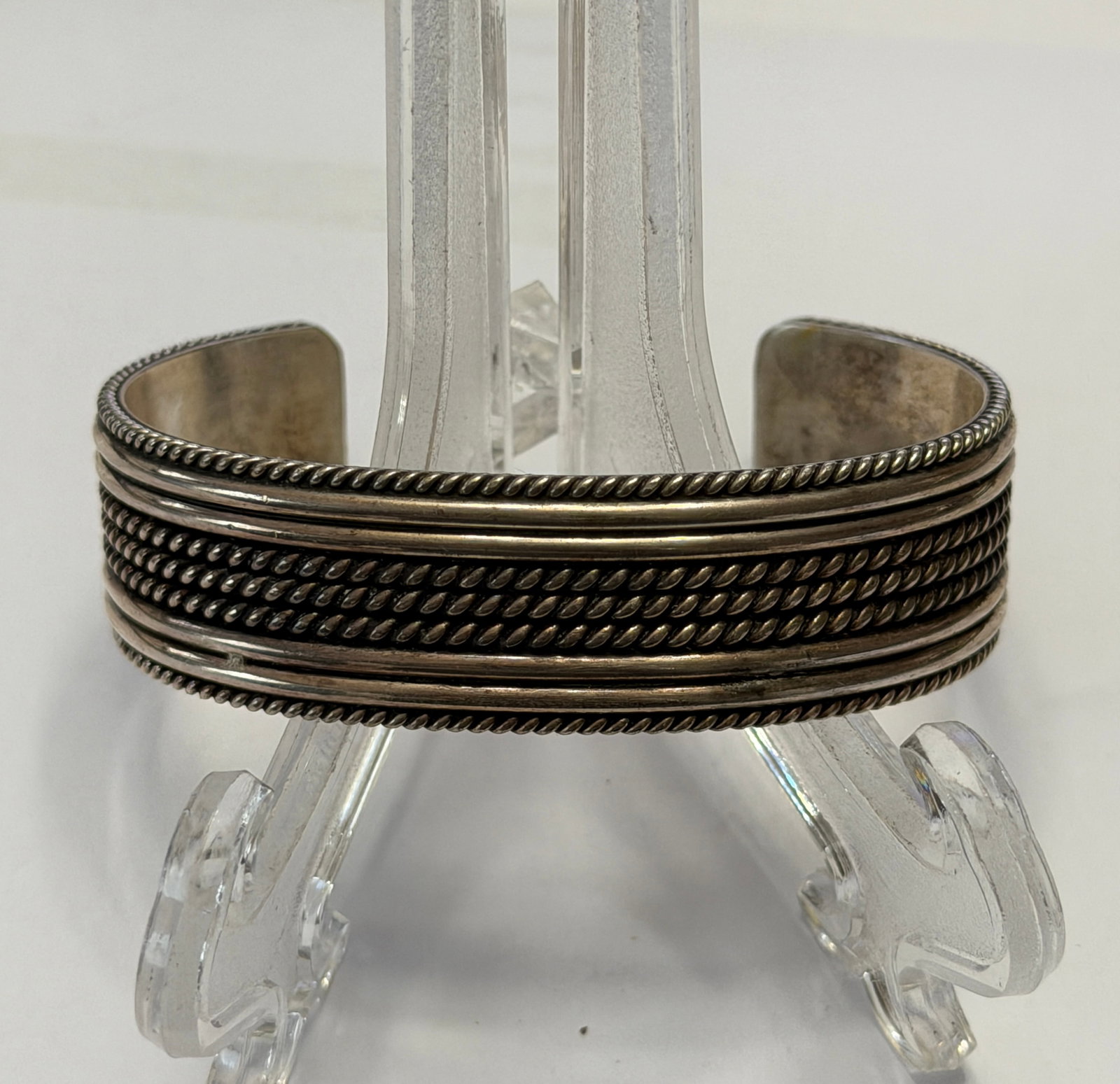 Designer Ron Y. Sterling Silver Cuff Bangle Bracelet: Striking designer cuff bracelet by Ron Y., crafted in solid sterling silver and featuring a bold, textured multi-row design. The piece showcases intricate rope and beaded detailing across the front, g