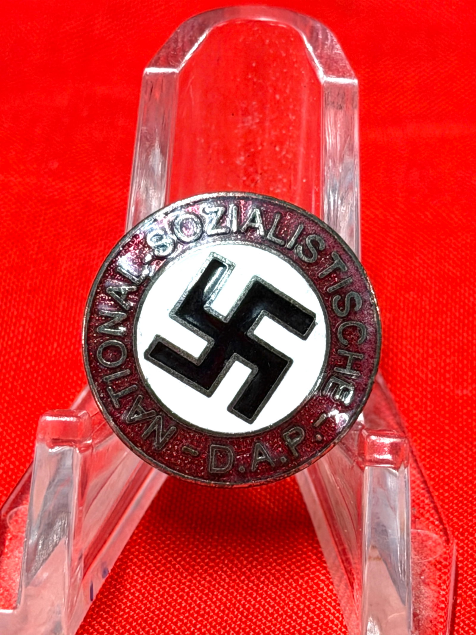 WW2 German D.A.P. National Socialist Enamel Lapel Pin Marked M1/29: WW2 era German National Socialist D.A.P. lapel pin featuring a black swastika on a white field surrounded by a red enamel border with “Nationalsozialistische D.A.P.” lettering. Reverse is mark