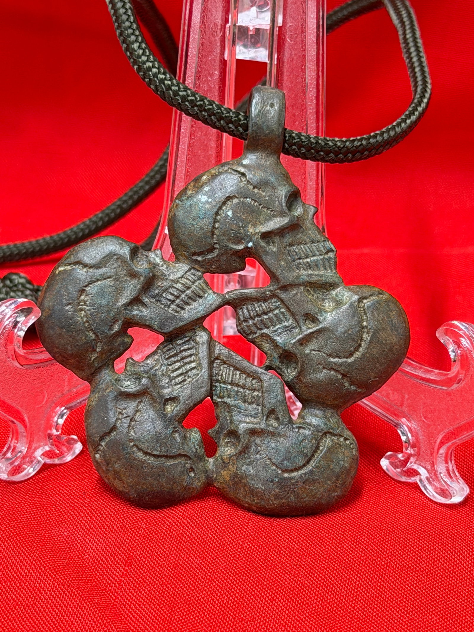 WW2 German SS Totenkopf Officer Skull Pendant Marked DRGM Berlin: WW2 era German SS Totenkopf style pendant featuring four interconnected skulls in an openwork circular design with integral suspension loop. Reverse bears a “DRGM Berlin” marking and the piece