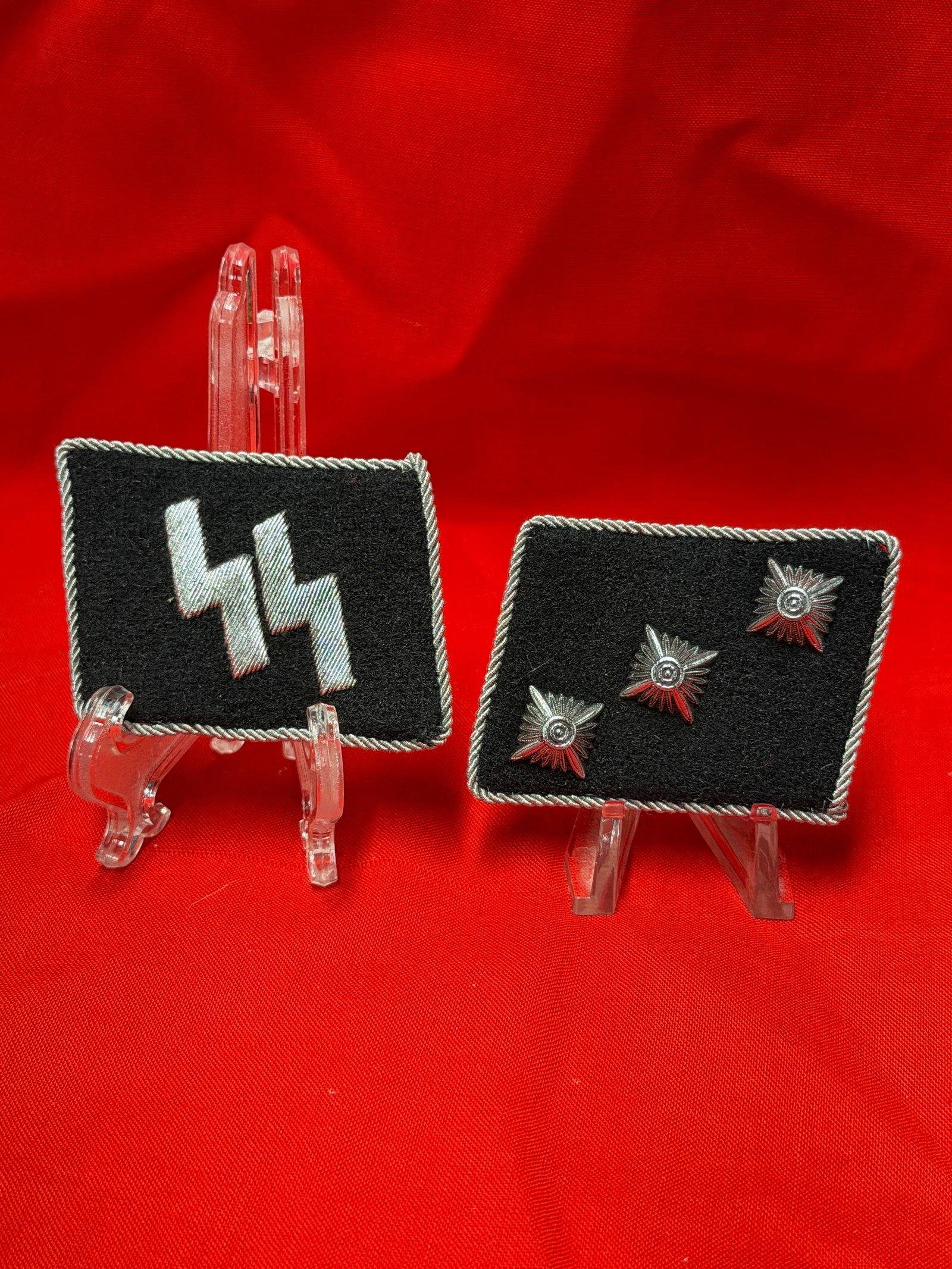WWII German Waffen-SS Collar Tab and Shoulder Board Rank Insignia Group with RZM Tag: WWII-era German Waffen-SS insignia grouping consisting of an SS runic collar tab together with a matching rank shoulder board or strap featuring three metal pips/star devices. The SS collar tab is con