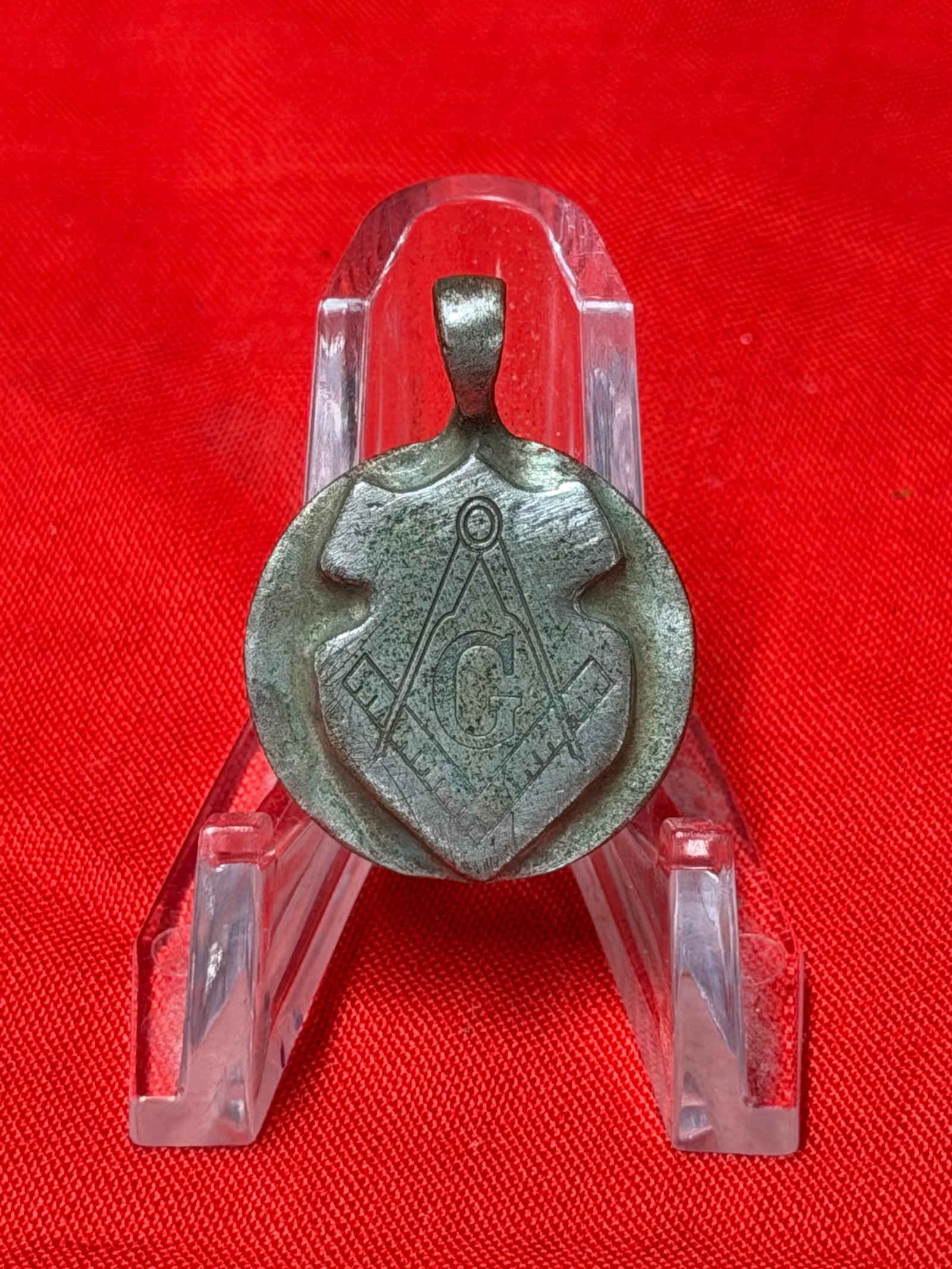 WWII German Masonic Pendant with Square and Compass Symbol: WWII German-era style pendant featuring the Masonic square and compass symbol with central “G” design to the front. In our opinion this pendant is silver-toned metal construction with a raised