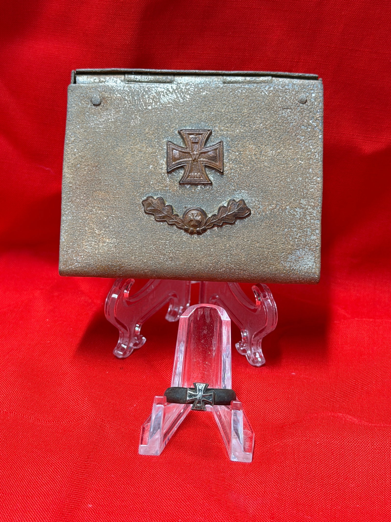 WWII German Iron Cross Ring in Presentation Case: WWII German-era Iron Cross themed ring displayed with matching metal presentation/storage case. In our opinion the ring features a raised Iron Cross design mounted to a dark-toned band with interior i