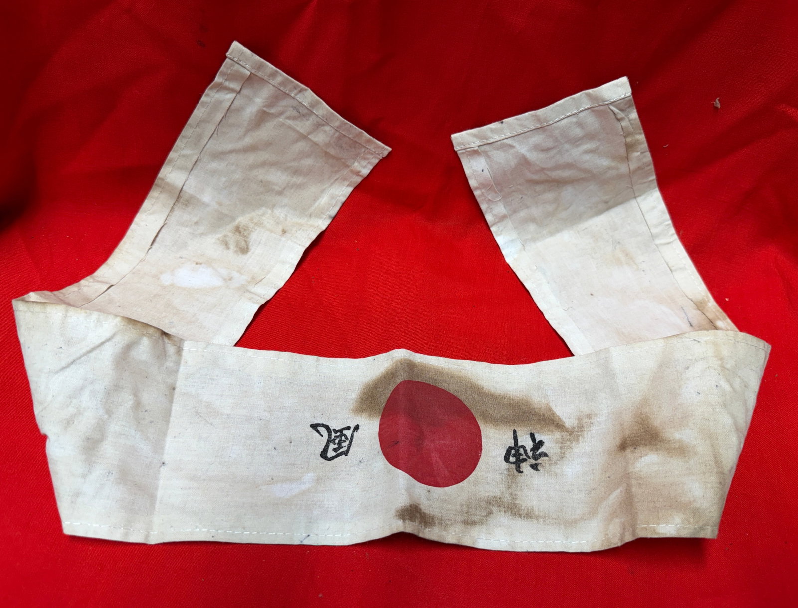 WW2 Japanese Military Hachimaki Headband Hinomaru Rising Sun Cloth Headband: WW2-era Japanese military style hachimaki headband featuring a central red Hinomaru sun emblem with hand-painted Japanese characters on each side. A classic form of patriotic and military headwear ass