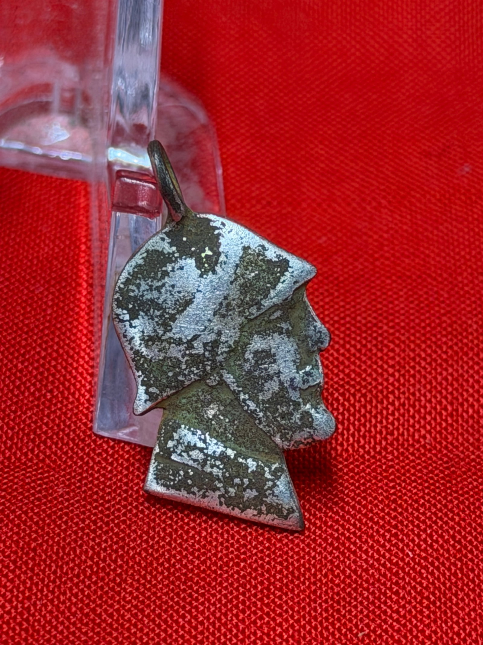 WWII German Soldier Head Pendant Charm: WWII German military-themed pendant charm featuring the profile bust of a helmeted soldier in the style of a German Stahlhelm helmet. The small metal charm displays a side-profile soldier portrait wit
