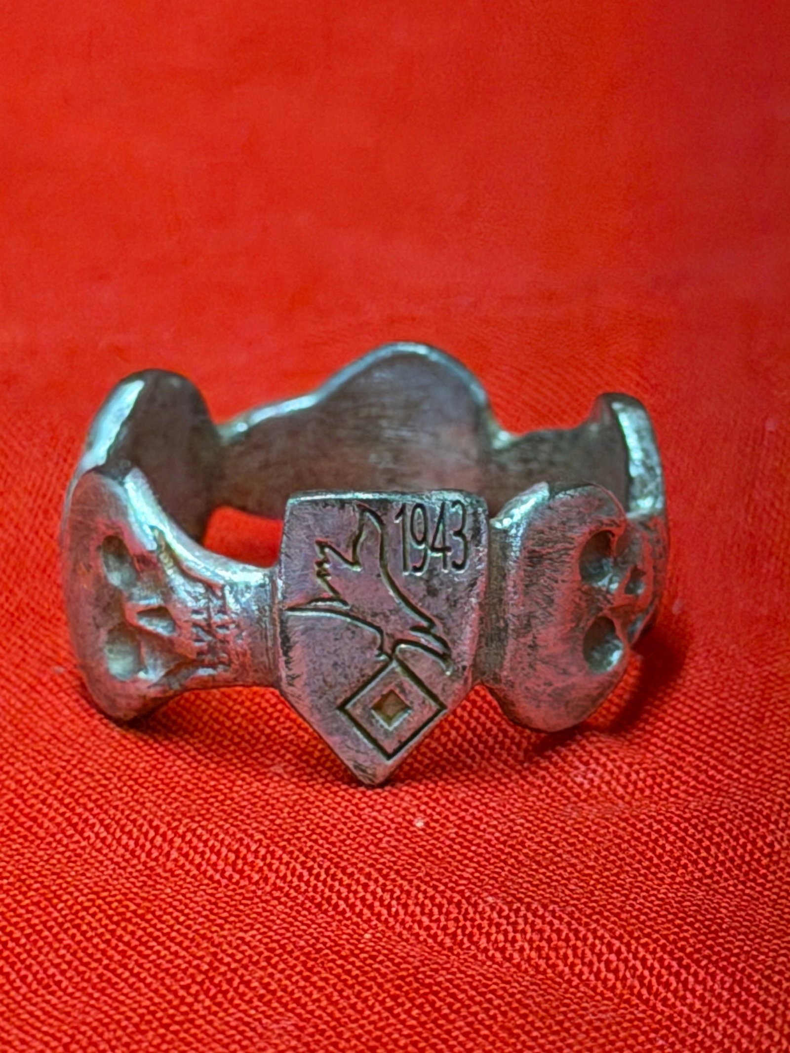 WWII German 1943 Luftwaffe Totenkopf Division Style Skull Ring – Military Commemorative Band: WWII-era German military-style commemorative ring featuring an elaborate Totenkopf skull motif band design with multiple raised skull details surrounding the ring. The front shield-style centerpiece i