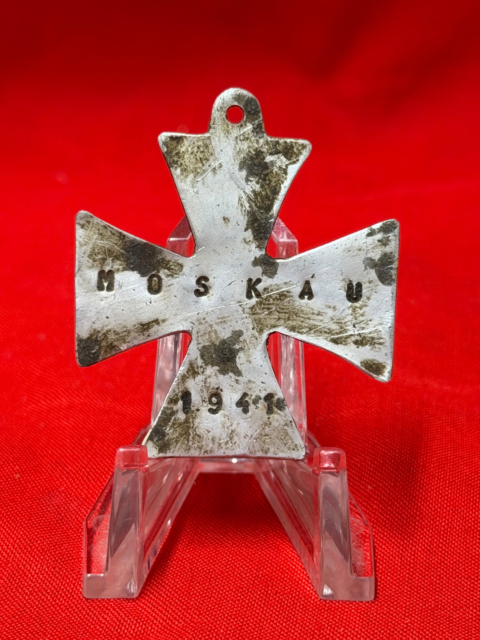 WWII German MOSKAU 1941 Cross Pendant Medal: German cross-shaped pendant marked “MOSKAU 1941” across the front in stamped lettering. Constructed in a silver-tone metal with a suspension loop at the top for wear as a pendant or attachment