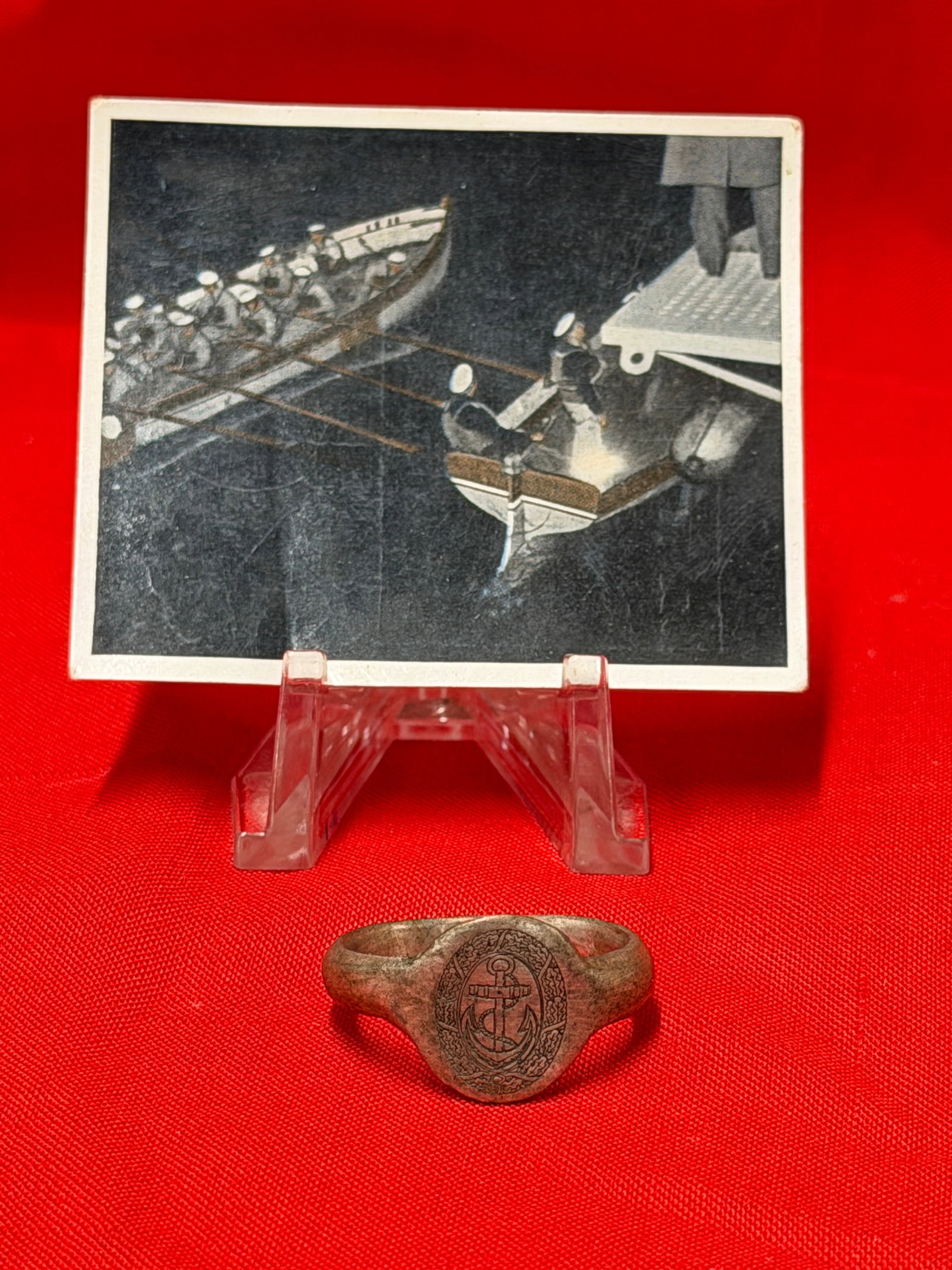 WWII German Kriegsmarine U-Boat Sailor Ring & Cigarette Card: German Kriegsmarine-themed lot featuring a silver-tone U-Boat sailor style ring together with a period Reichsmarine cigarette collector card. The ring displays a detailed naval anchor emblem within an