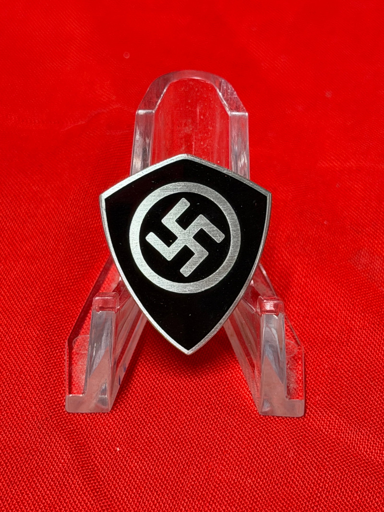 WWII Era German Shield Style Political Pin Badge w/ Swastika Emblem Marked Ges. Gesch.: Vintage shield-shaped German political style pin badge featuring a black enamel-style field with silver-tone border and central swastika emblem enclosed within a circular design. The reverse is stampe