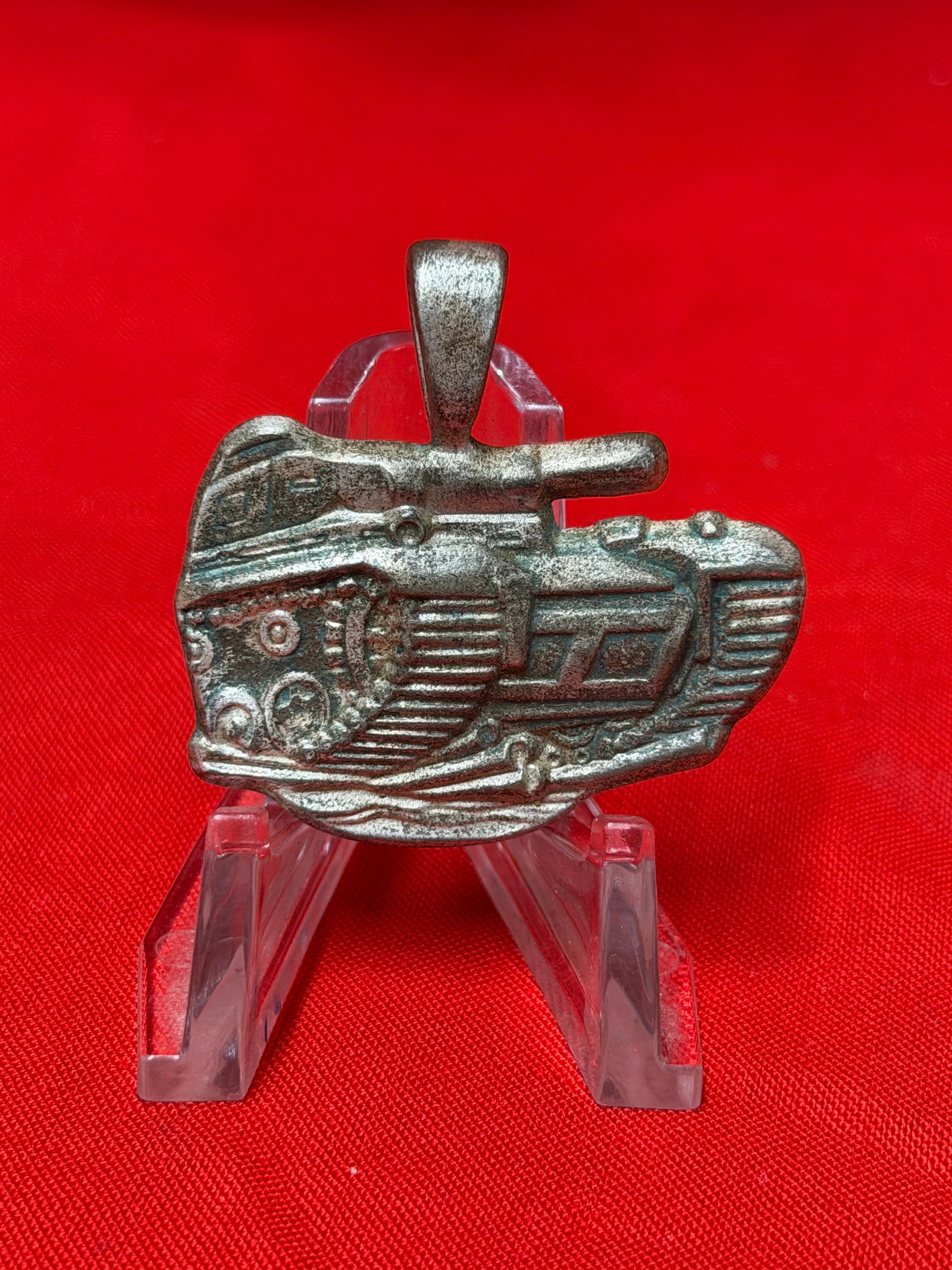WWII Era German Panzer Division Style Tank Pendant Charm: WWII era German Panzer division style pendant featuring a detailed armored tank design in cast metal relief. The piece depicts a tracked military tank with raised turret, cannon barrel, tread details,
