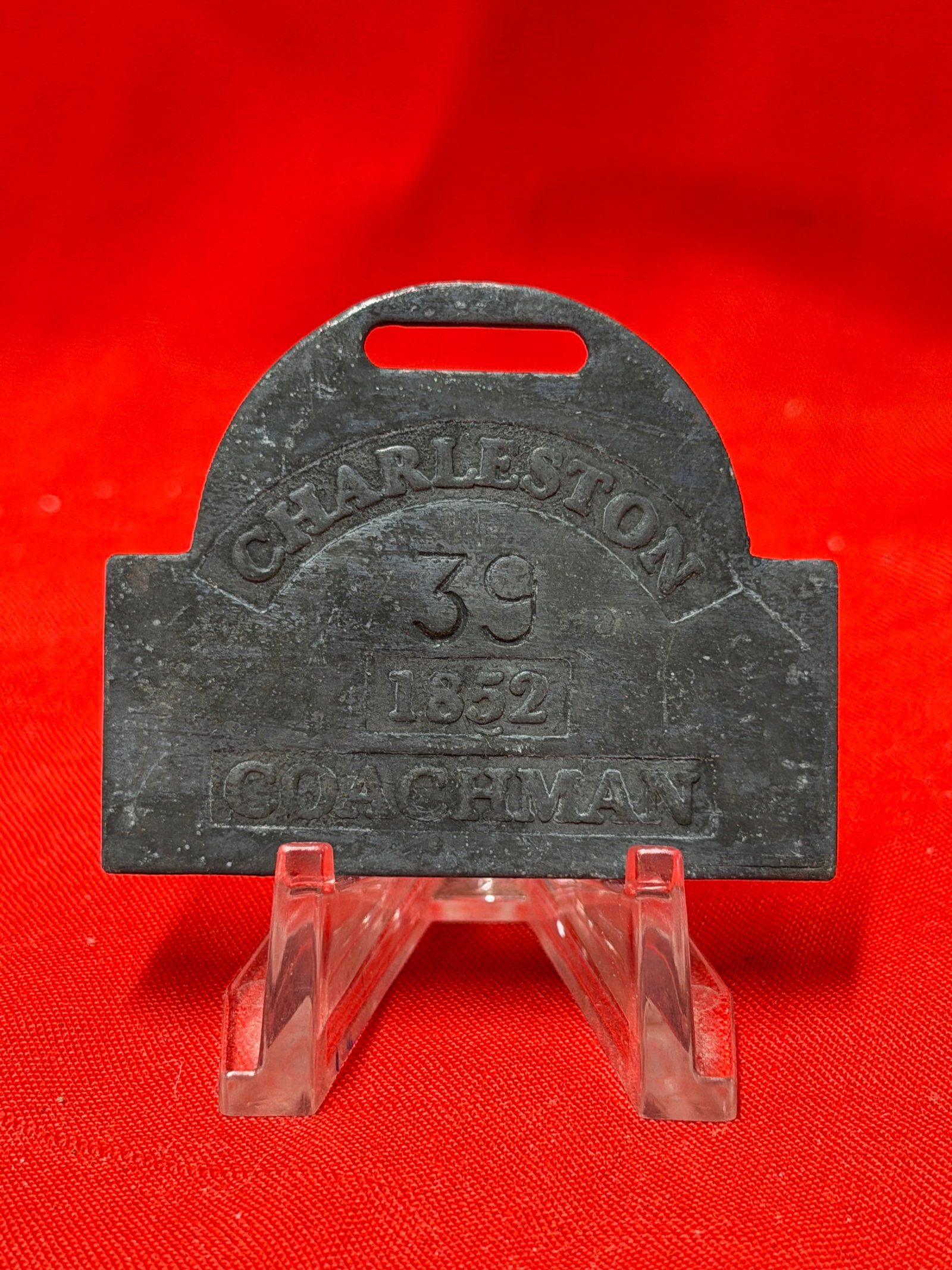 Antique 1852 Charleston Coachman Slave Tag Number 39 Historical Relic: Antique metal slave tag marked “Charleston 39 1852 Coachman.” Features occupation designation, serial number, and slotted attachment opening at top for wear or display. In our opinion this pie