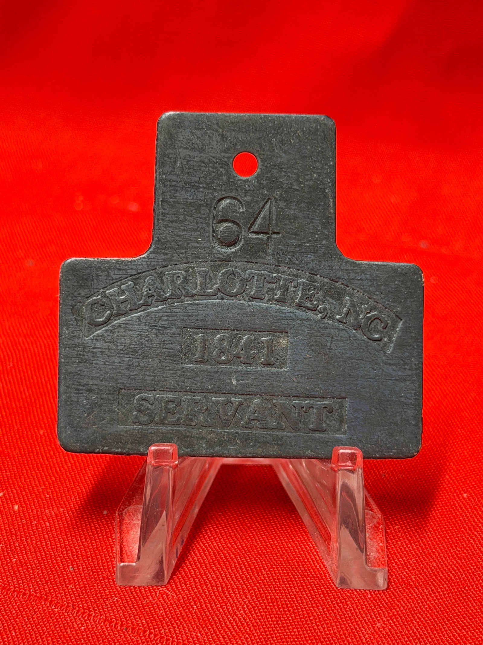 Charleston Servant Badge Slave Tag No. 64 1841 Metal Identification Tag: Charleston servant badge numbered 64 and dated 1841 with raised lettering and dark aged surface patina. In our opinion this is an early occupational identification badge from Charleston, South Carolin