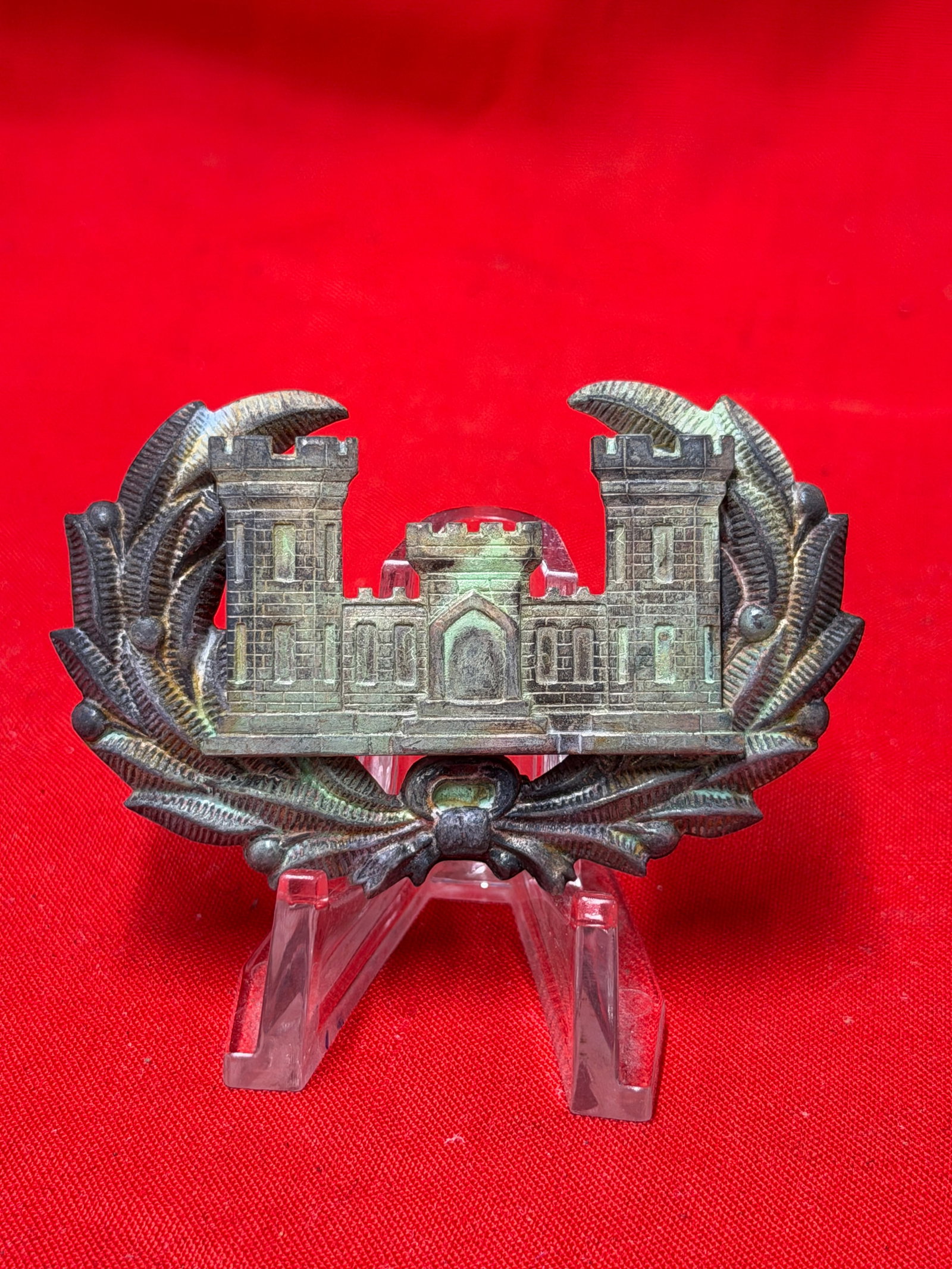 Large crescent shaped brass gorget style military neck plate featuring an applied crowned crest: Decorative brass Civil War Engineer Corps style headgear badge featuring fortress castle imagery surrounded by wreath detailing with rear attachment hardware still present. In our opinion, this piece 