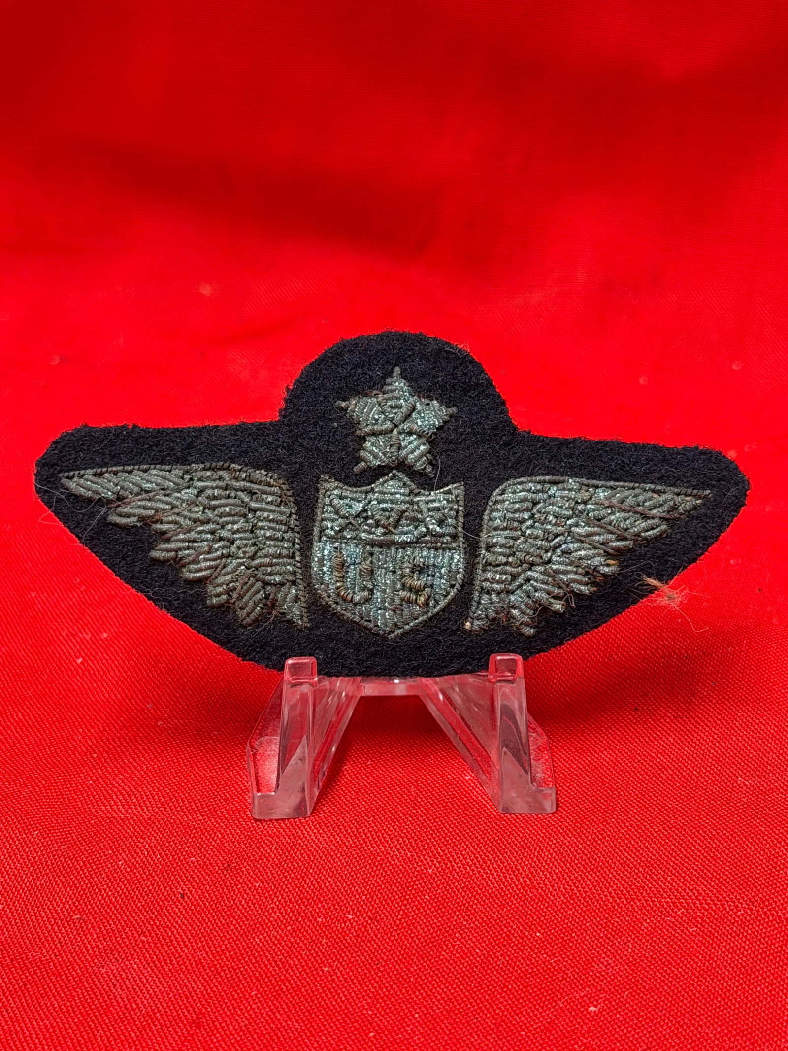 WW1 Era US Aviator Bullion Wings Patch Military Uniform Insignia: Black felt backed bullion insignia featuring spread wings, central US shield, and star above in aviator style design. In our opinion this piece resembles a World War One era US military aviator or avi